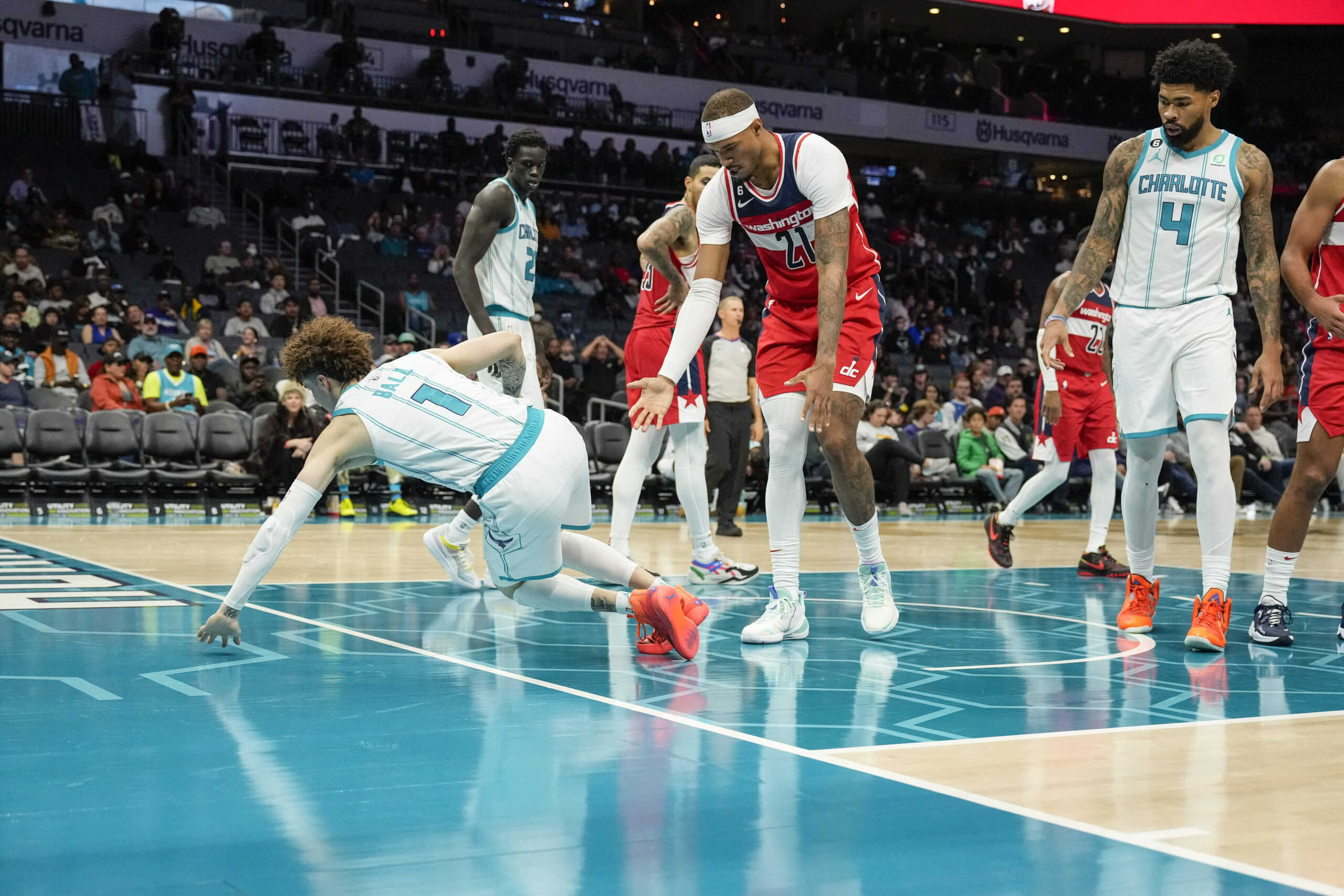 Oct 10, 2022; Charlotte, North Carolina, USA; Charlotte Hornets guard LaMelo Ball (1) goes down after turning his ankle while driving the lane against the Washington Wizards during the second half at Spectrum Center. Mandatory Credit: Jim Dedmon-USA TODAY Sports