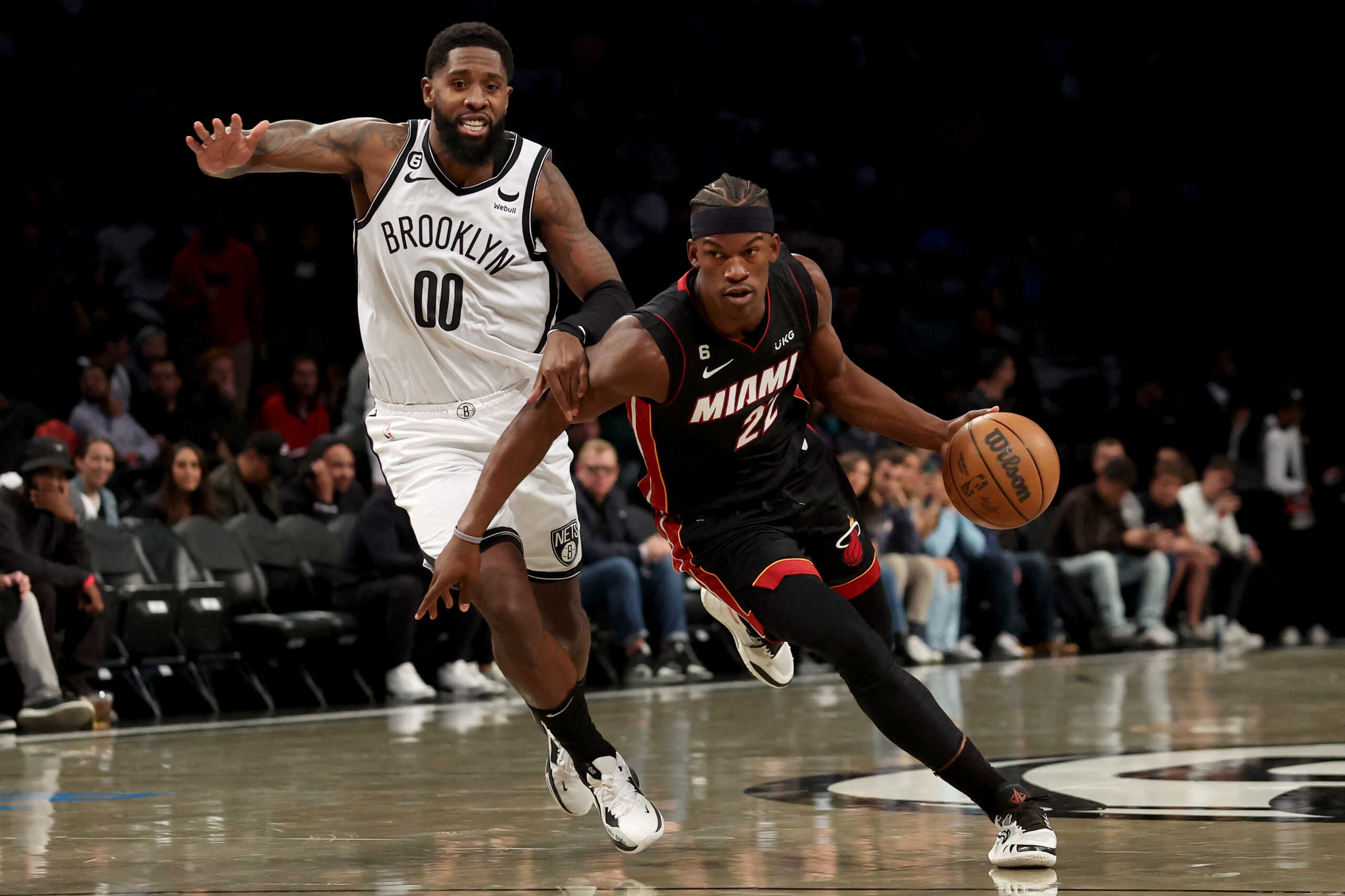 Oct 6, 2022; Brooklyn, New York, USA; Miami Heat forward Jimmy Butler (22) drives to the basket against Brooklyn Nets forward Royce O'Neale (00) during the first quarter at Barclays Center. Mandatory Credit: Brad Penner-USA TODAY Sports