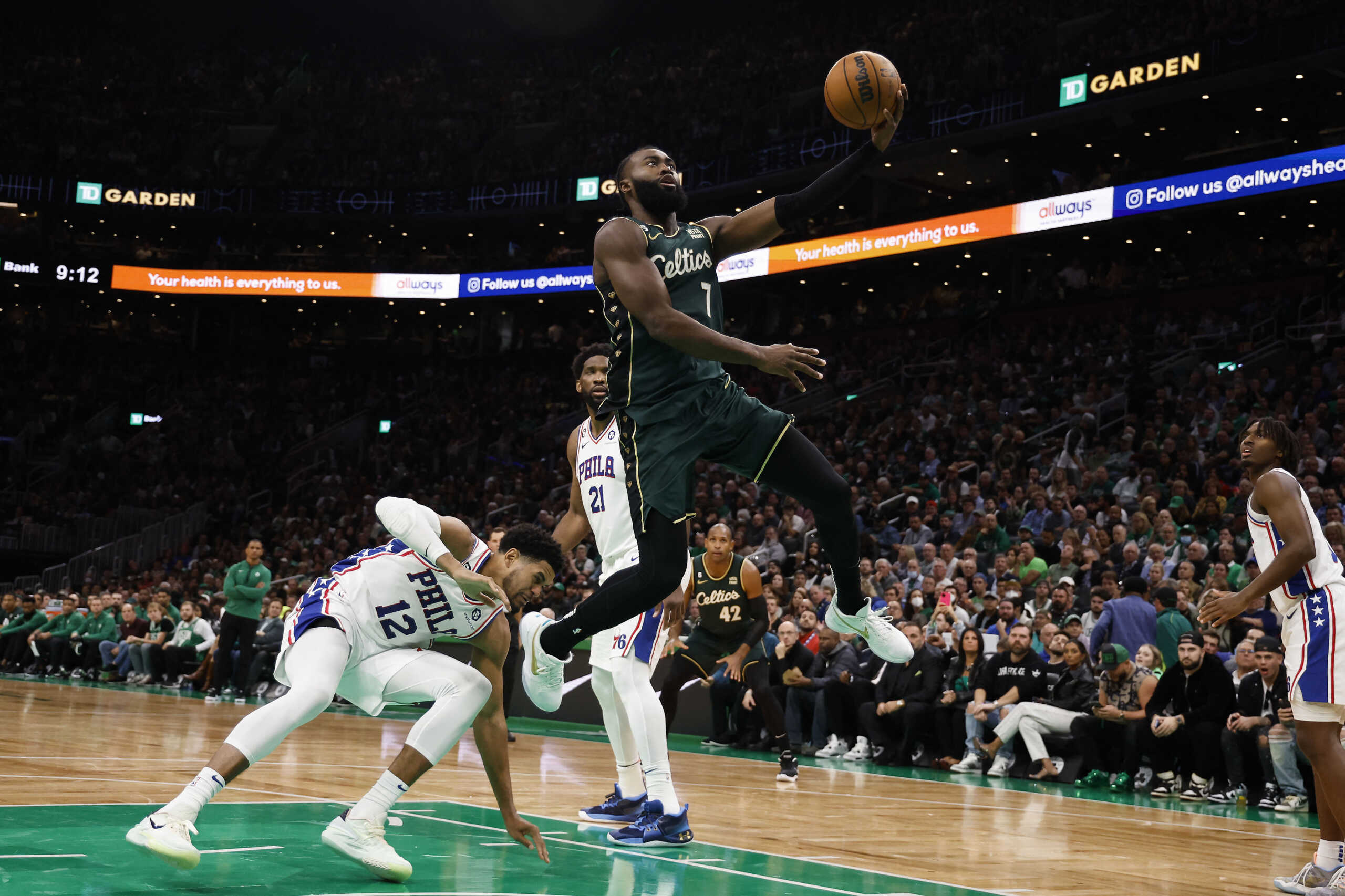 Oct 18, 2022; Boston, Massachusetts, USA; Boston Celtics guard Jaylen Brown (7) goes to the basket past Philadelphia 76ers forward Tobias Harris (12) during the third quarter at TD Garden. Mandatory Credit: Winslow Townson-USA TODAY Sports