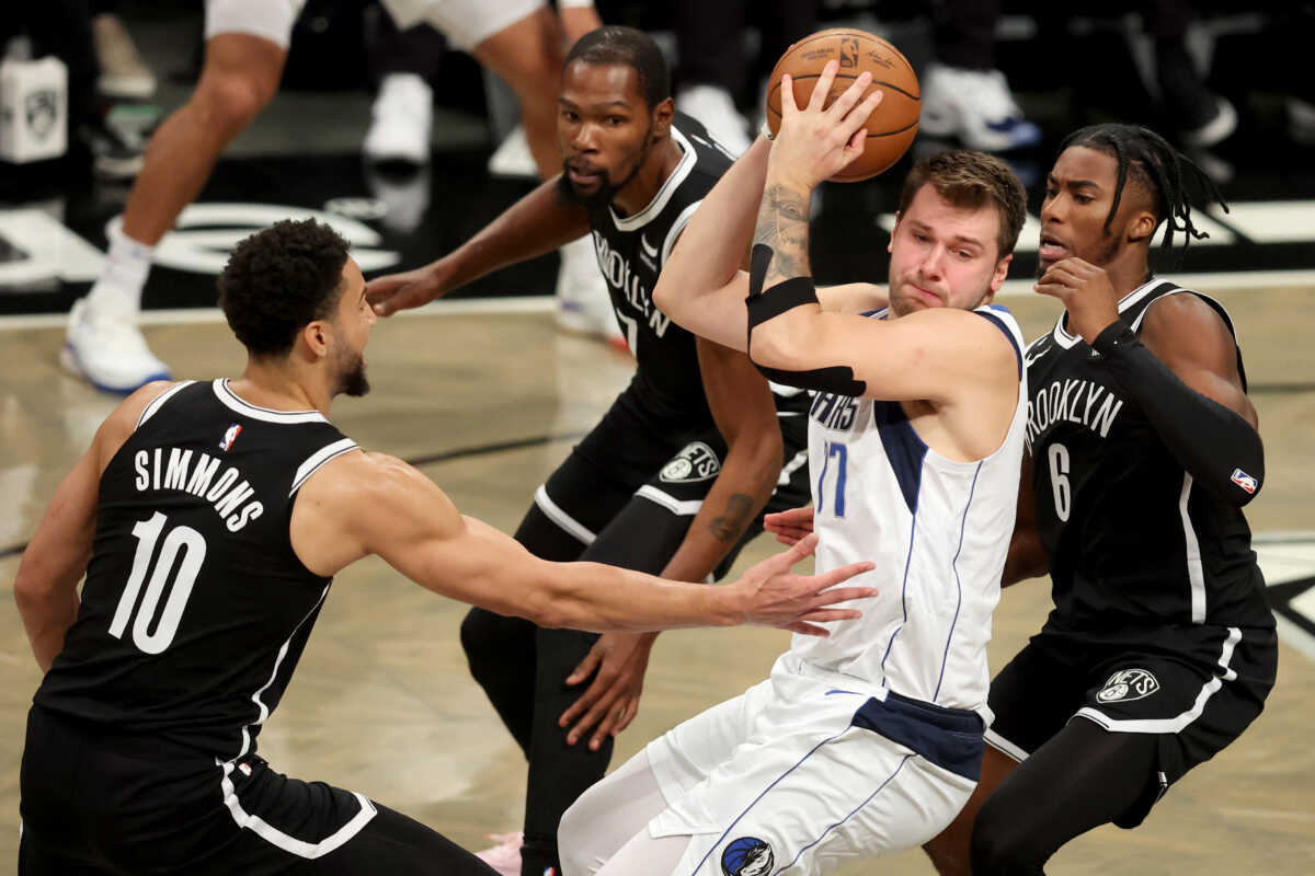 Oct 27, 2022; Brooklyn, New York, USA; Dallas Mavericks guard Luka Doncic (77) drives to the basket against Brooklyn Nets guard Ben Simmons (10) and forward Kevin Durant (7) and forward David Duke Jr. (6) during the second quarter at Barclays Center. Mandatory Credit: Brad Penner-USA TODAY Sports