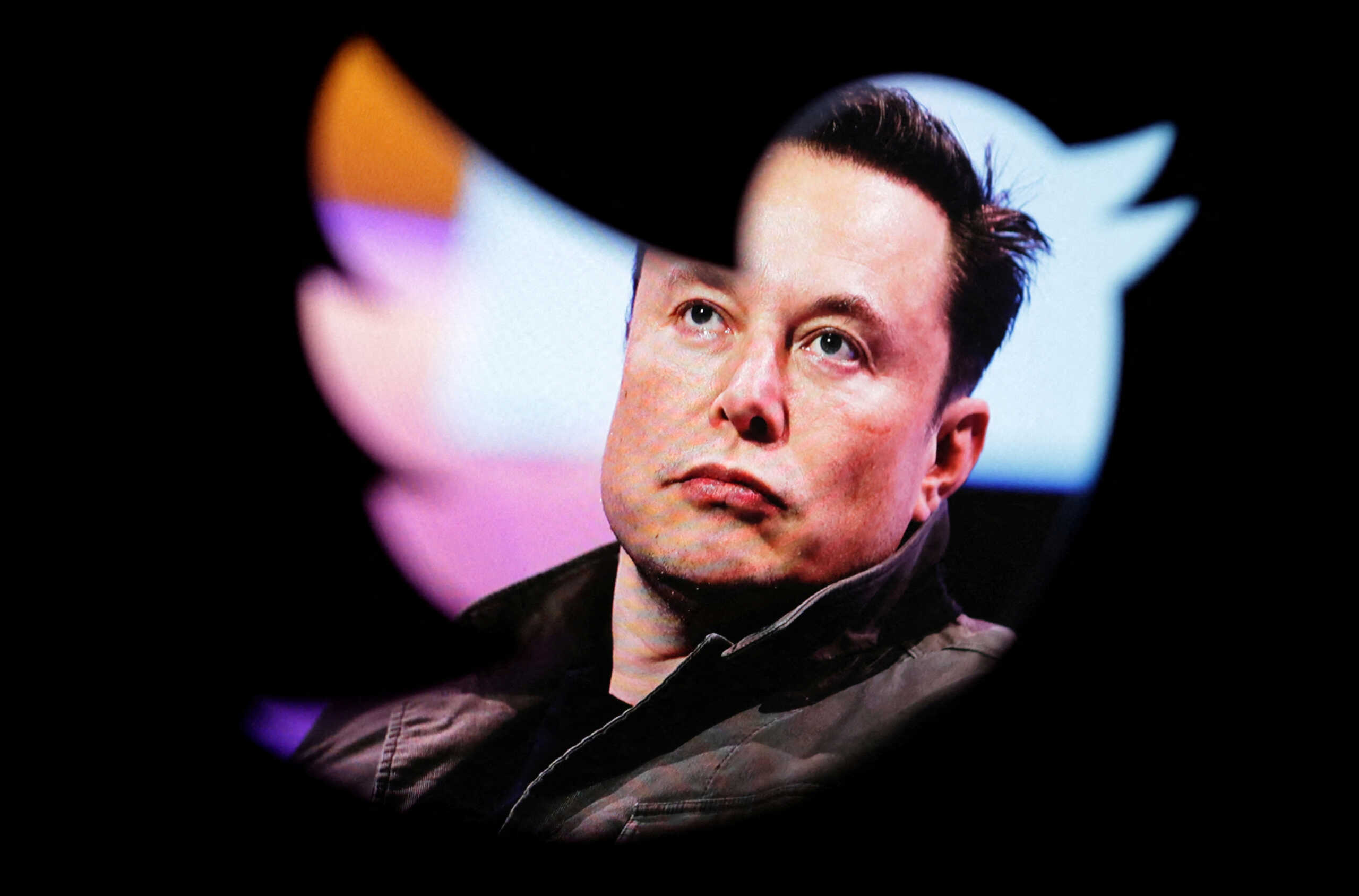 FILE PHOTO: Elon Musk's photo is seen through a Twitter logo in this illustration taken October 28, 2022. REUTERS
