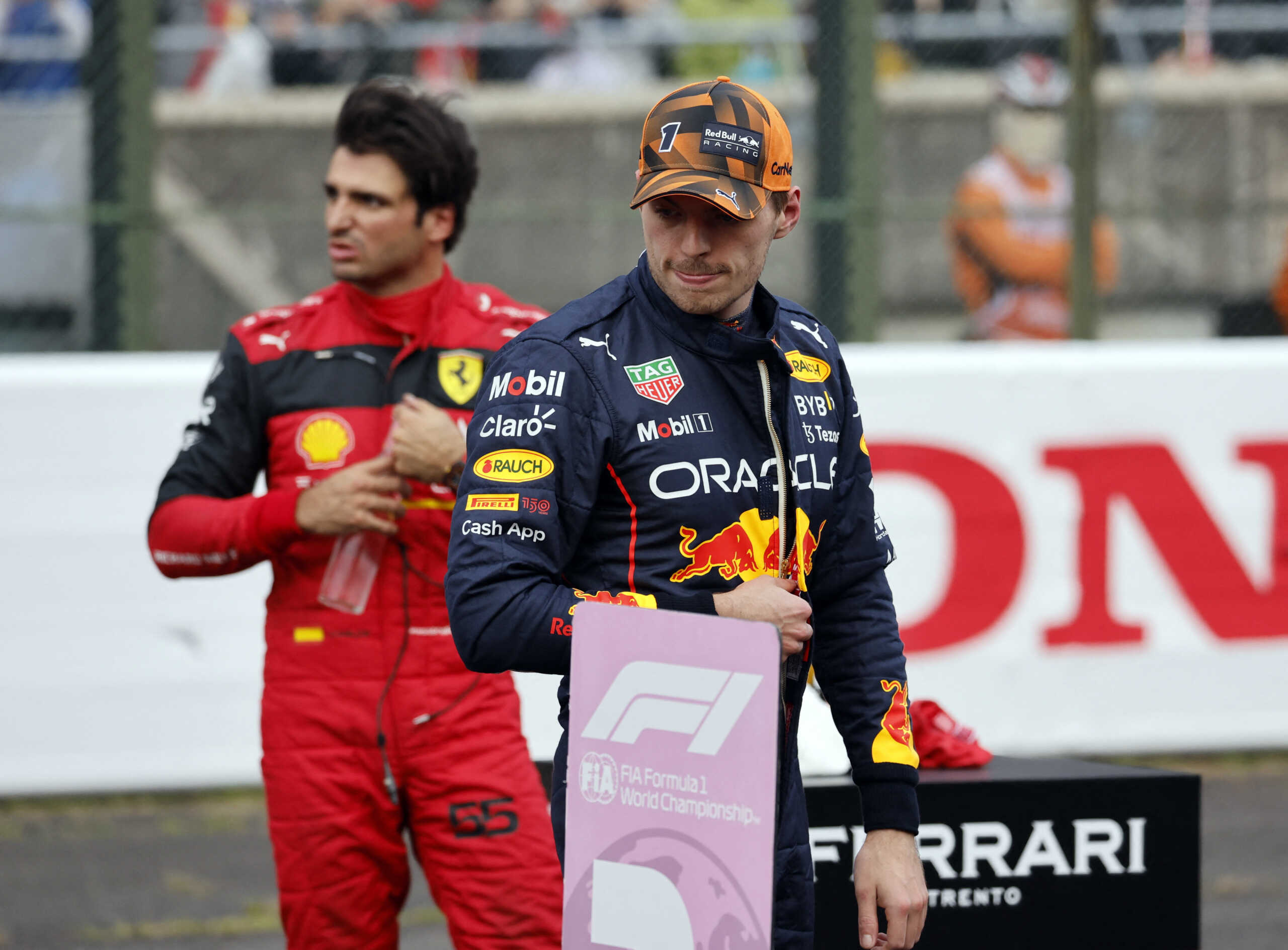 Formula One F1 - Japanese Grand Prix - Suzuka Circuit, Suzuka, Japan - October 8, 2022 Red Bull's Max Verstappen celebrates qualifying in pole position as third placed Ferrari's Carlos Sainz Jr. looks on REUTERS