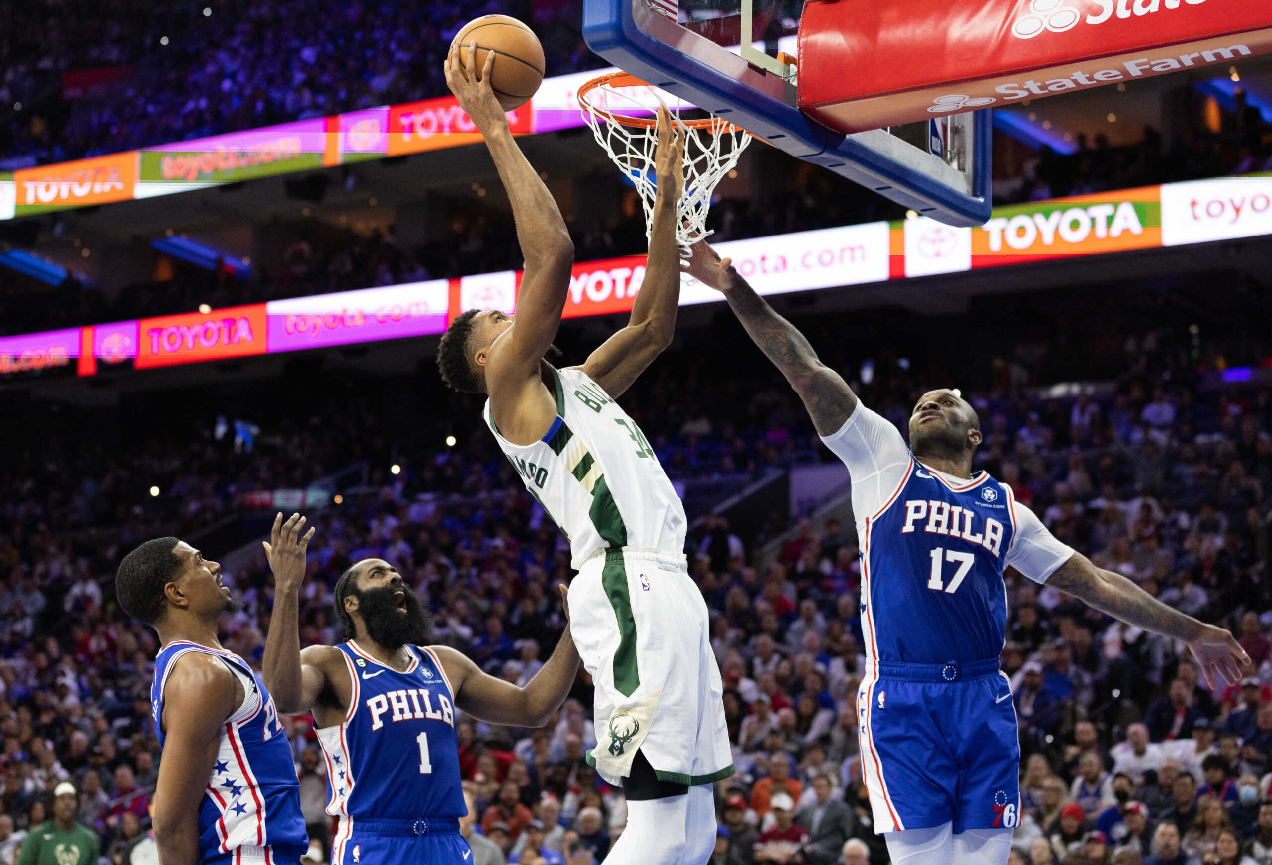 Oct 20, 2022; Philadelphia, Pennsylvania, USA; Milwaukee Bucks forward Giannis Antetokounmpo (34) drives for a shot against Philadelphia 76ers forward P.J. Tucker (17) and guard James Harden (1) during the fourth quarter at Wells Fargo Center. Mandatory Credit: Bill Streicher-USA TODAY Sports