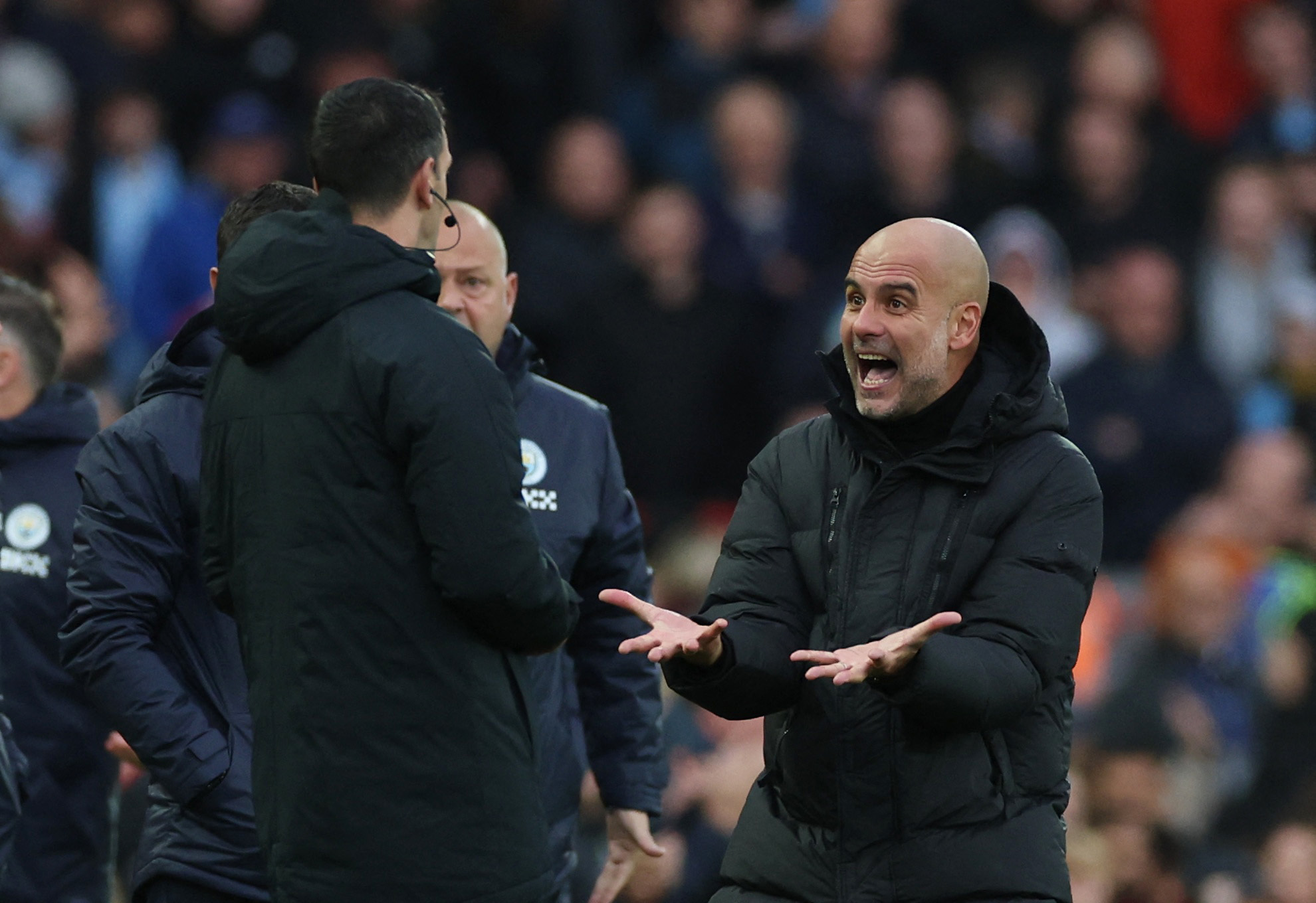 Soccer Football - Premier League - Liverpool v Manchester City - Anfield, Liverpool, Britain - October 16, 2022 Manchester City manager Pep Guardiola remonstrates with the fourth official after Phil Foden's goal was disallowed REUTERS