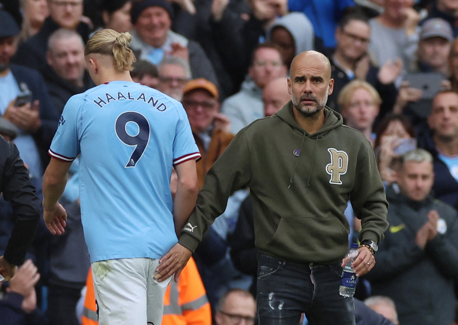 Soccer Football - Premier League - Manchester City v Brighton & Hove Albion - Etihad Stadium, Manchester, Britain - October 22, 2022 Manchester City's Erling Braut Haaland with manager Pep Guardiola after being substituted REUTERS