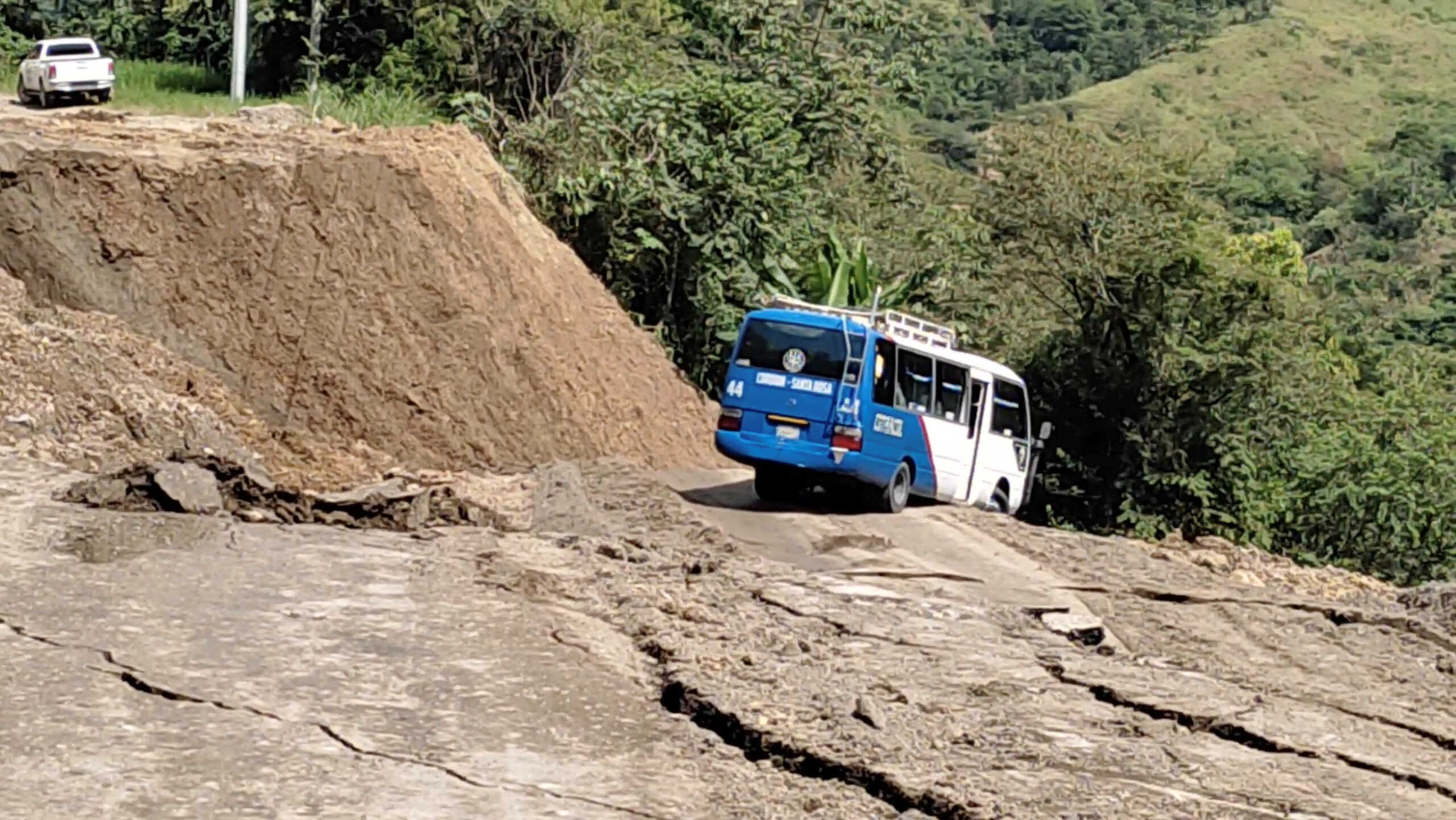 A stranded bus is dragged downhill during a landslide in Cucuyagua, Honduras September 23, 2022, in this screengrab obtained from a social media video. Adan Josue Romero via REUTERS  THIS IMAGE HAS BEEN SUPPLIED BY A THIRD PARTY. MANDATORY CREDIT. NO RESALES. NO ARCHIVES.