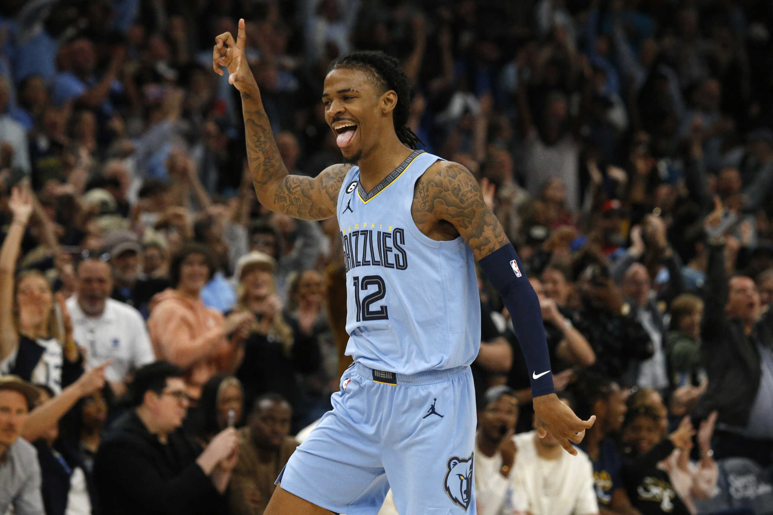 Oct 24, 2022; Memphis, Tennessee, USA; Memphis Grizzlies guard Ja Morant (12) reacts after a basket during the second half against the Brooklyn Nets at FedExForum. Mandatory Credit: Petre Thomas-USA TODAY Sports