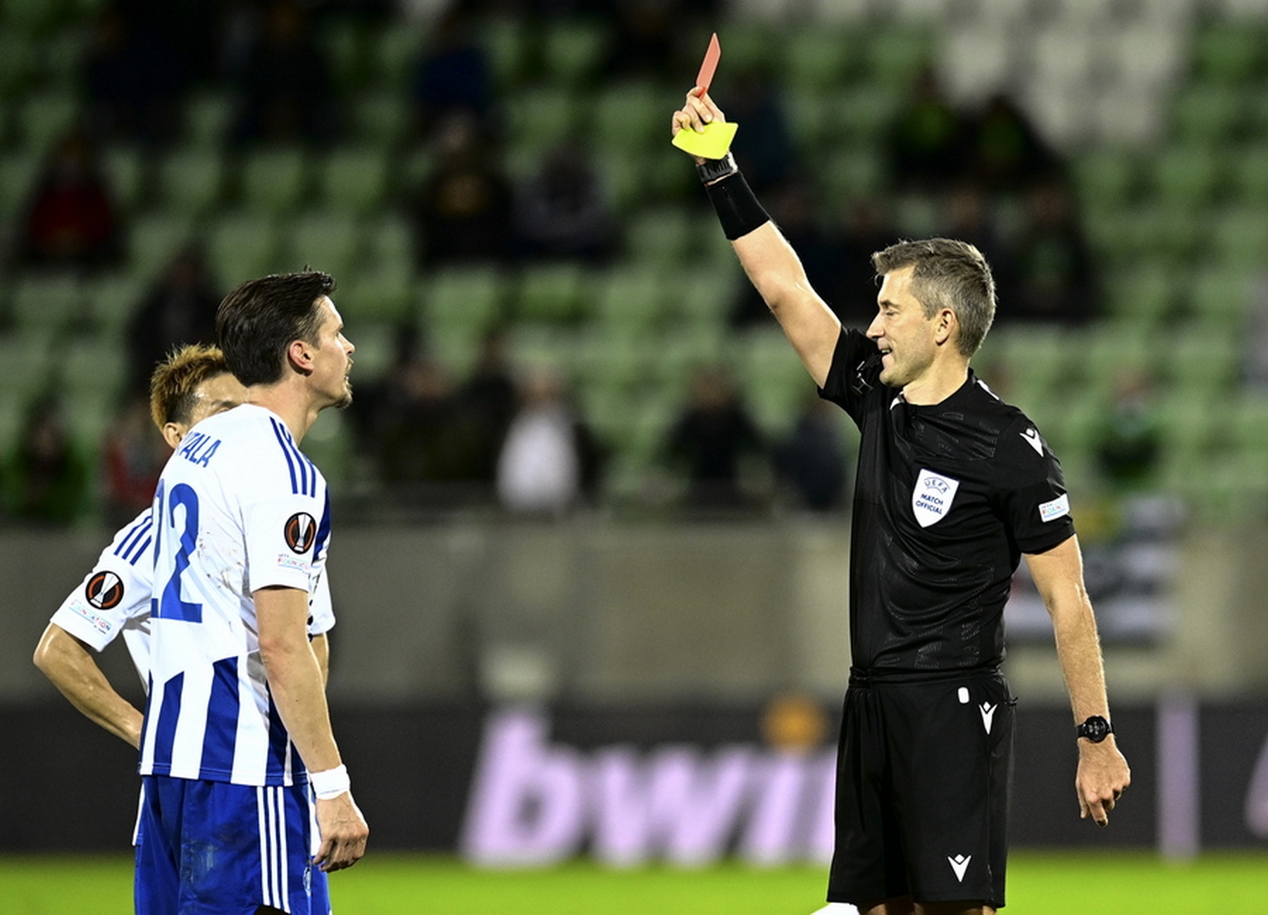 epa10242287 Referee Kristo Tohver (R) shows the red card to Jukka Raitala (L) of HJK during the UEFA Europa League group C soccer match between Ludogorets and HJK Helsinki in Razgrad, Bulgaria, 13 October 2022.  EPA