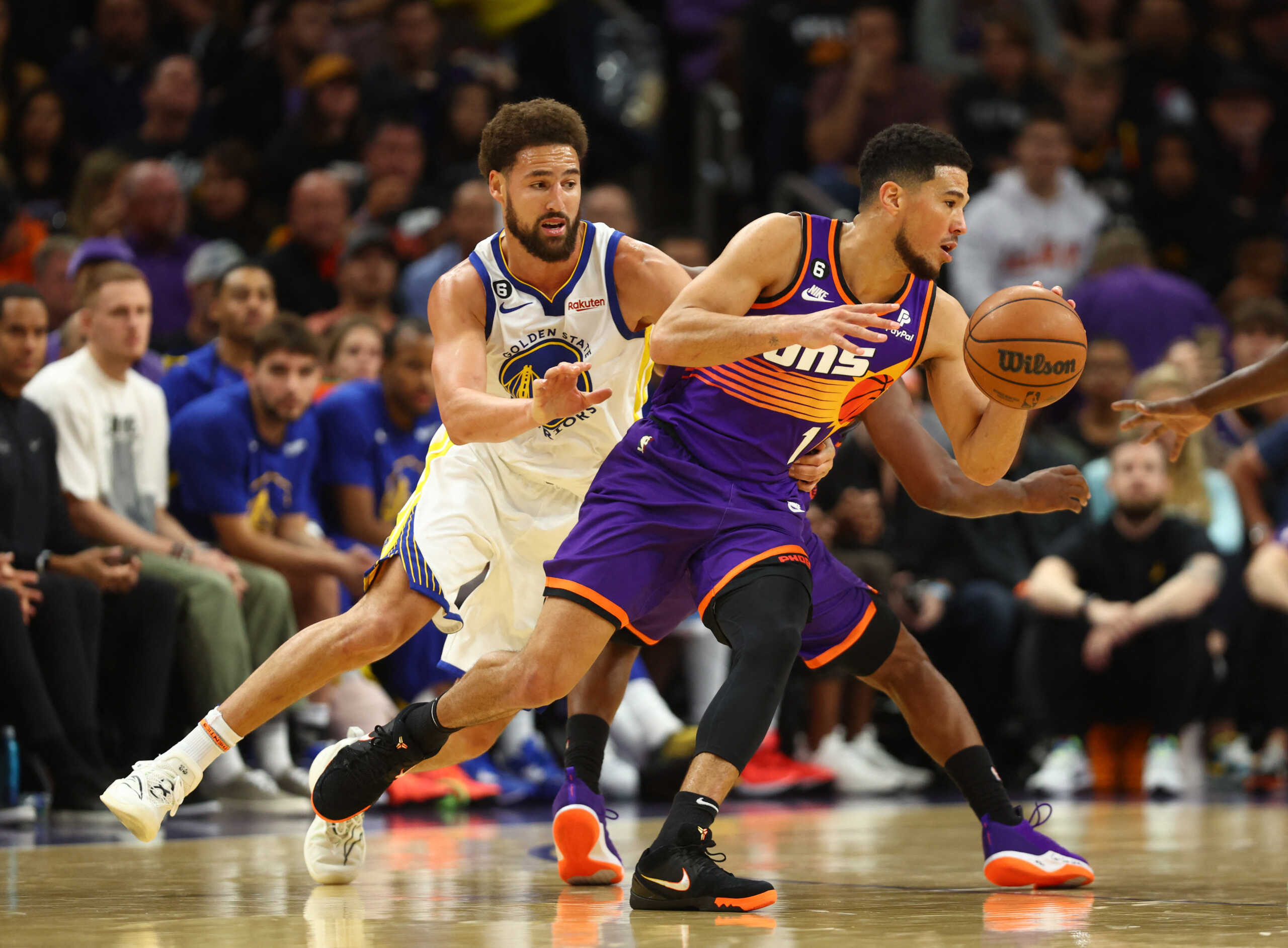 Oct 25, 2022; Phoenix, Arizona, USA; Phoenix Suns guard Devin Booker (1) moves the ball against Golden State Warriors guard Klay Thompson in the second half at Footprint Center. Mandatory Credit: Mark J. Rebilas-USA TODAY Sports