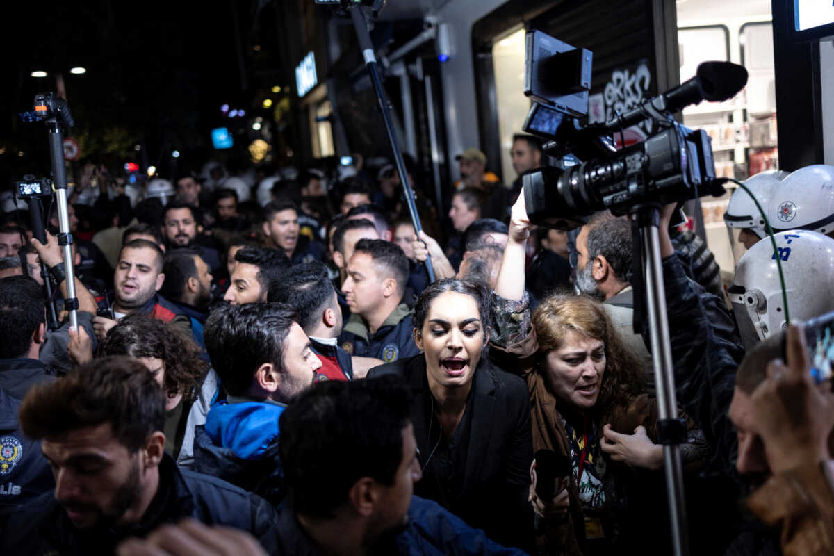 Riot and plain clothes police officers scuffle with journalists as they try to film a protest about the detention of the head of the Turkish Medical Association (TTB), Sebnem Korur Fincanci, over statements she made last week in which she commented on alleged chemical weapons' use by the Turkish armed forces in Istanbul, Turkey, October 26, 2022. REUTERS