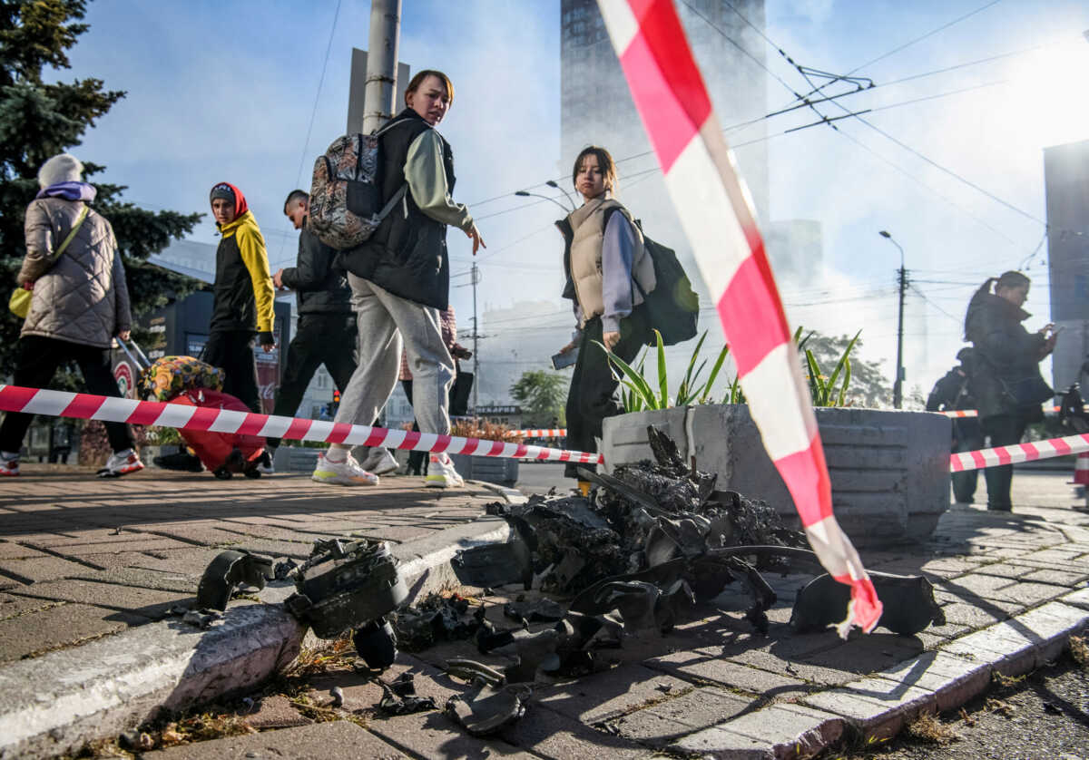 FILE PHOTO: Local residents look at parts of an unmanned aerial vehicle (UAV), what Ukrainian authorities consider to be an Iranian-made drone Shahed-136, after Russian drone strike, amid Russia's attack on Ukraine, in Kyiv, Ukraine October 17, 2022. REUTERS