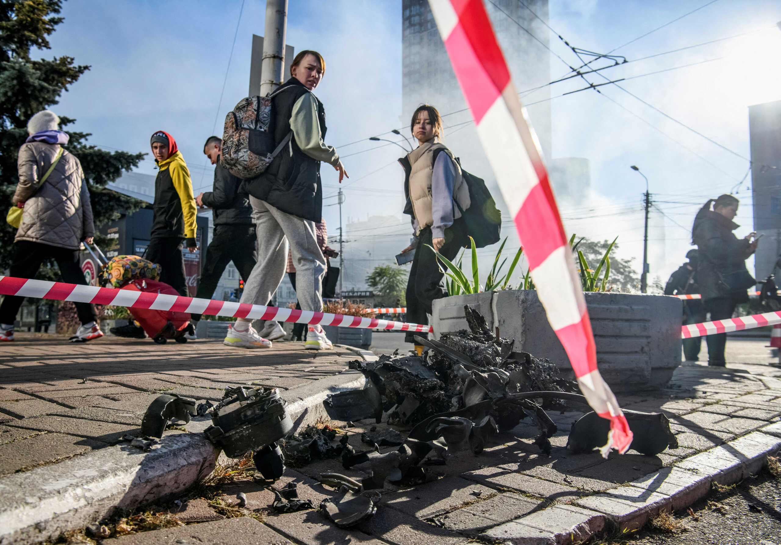 FILE PHOTO: Local residents look at parts of an unmanned aerial vehicle (UAV), what Ukrainian authorities consider to be an Iranian-made drone Shahed-136, after Russian drone strike, amid Russia's attack on Ukraine, in Kyiv, Ukraine October 17, 2022. REUTERS