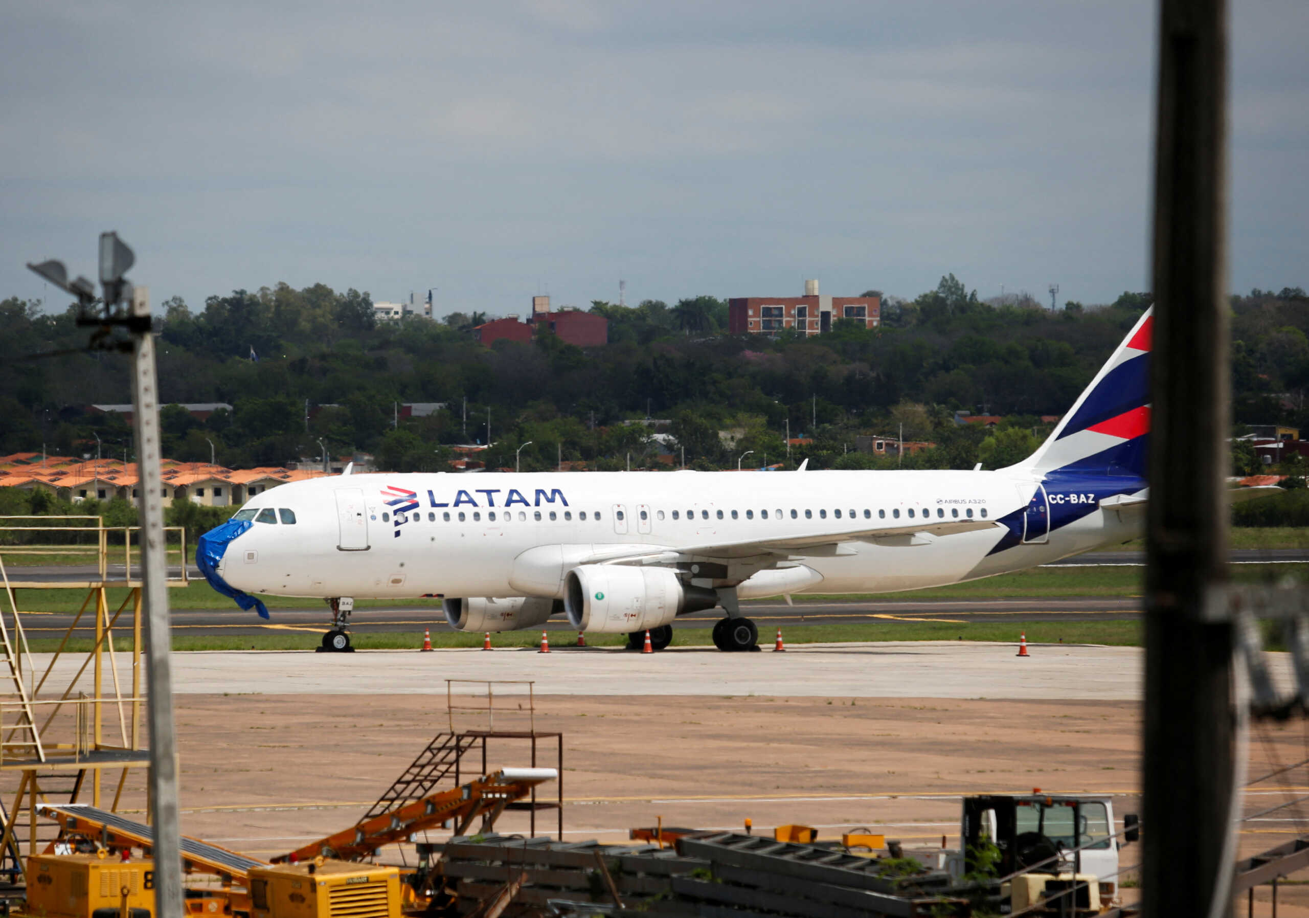 An Airbus-320, operated by LATAM Paraguay, is parked at the Silvio Pettirossi International Airport, as Paraguay's aviation authority said on Thursday it had opened an investigation after verifying damage to the plane including the destruction of the aircraft's "nose" following an emergency landing in the midst of a severe storm, in Luque, Paraguay, October 27, 2022. REUTERS