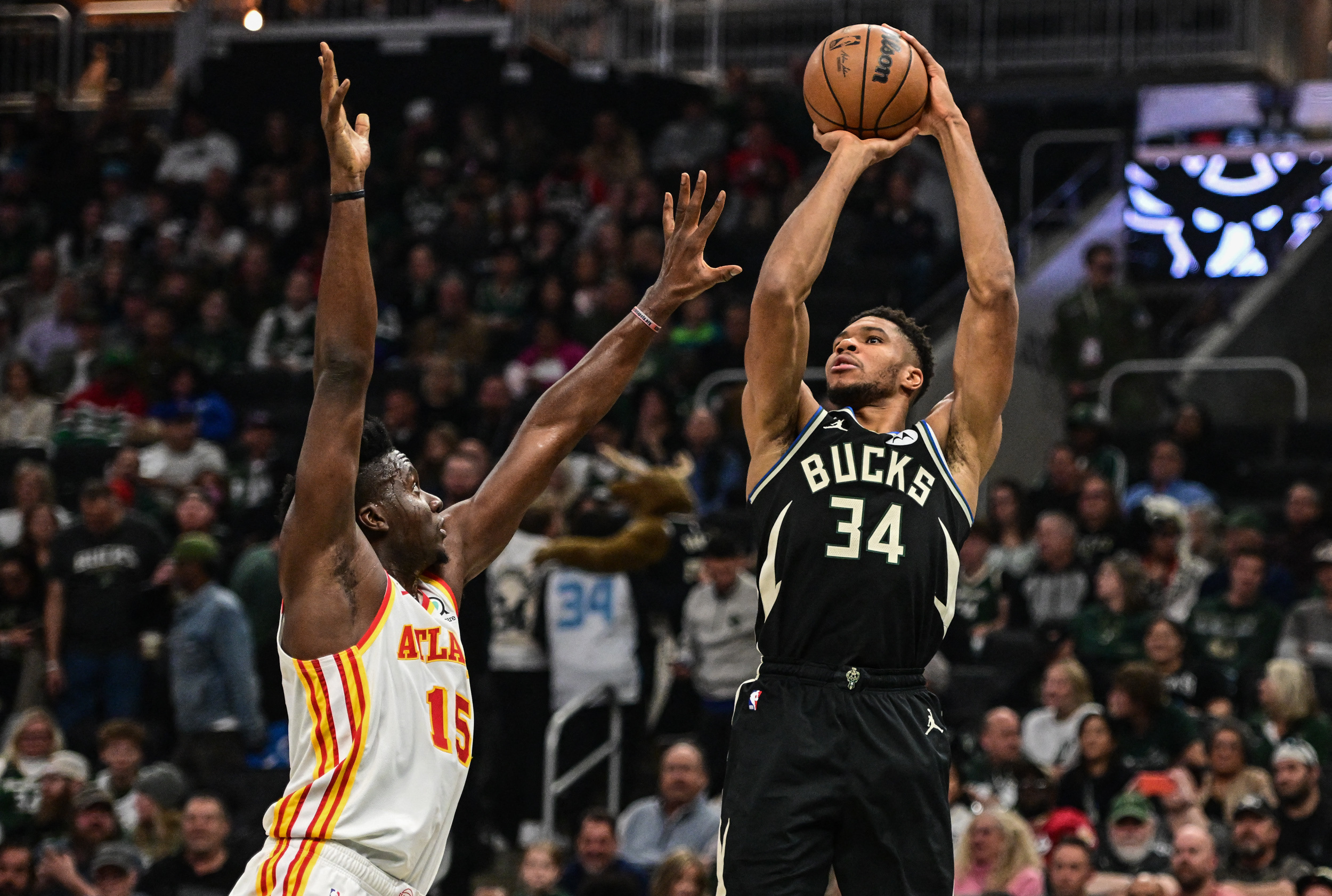 Oct 29, 2022; Milwaukee, Wisconsin, USA;  Milwaukee Bucks forward Giannis Antetokounmpo (34) takes a shot against Atlanta Hawks center Clint Capela (15) in the first quarter at Fiserv Forum. Mandatory Credit: Benny Sieu-USA TODAY Sports