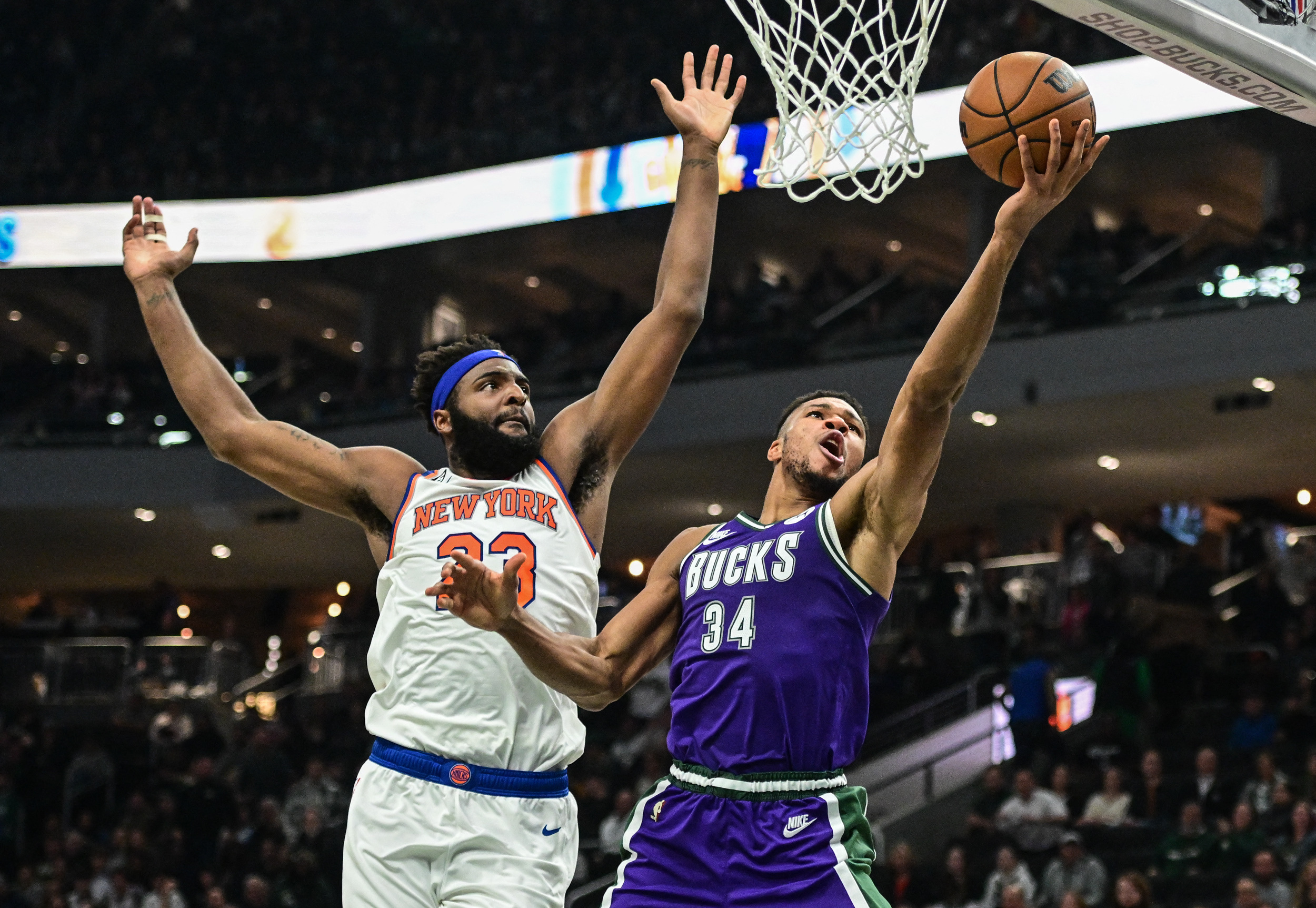Oct 28, 2022; Milwaukee, Wisconsin, USA;  Milwaukee Bucks forward Giannis Antetokounmpo (34) takes a shot against New York Knicks center Mitchell Robinson (23) in the second quarter at Fiserv Forum. Mandatory Credit: Benny Sieu-USA TODAY Sports