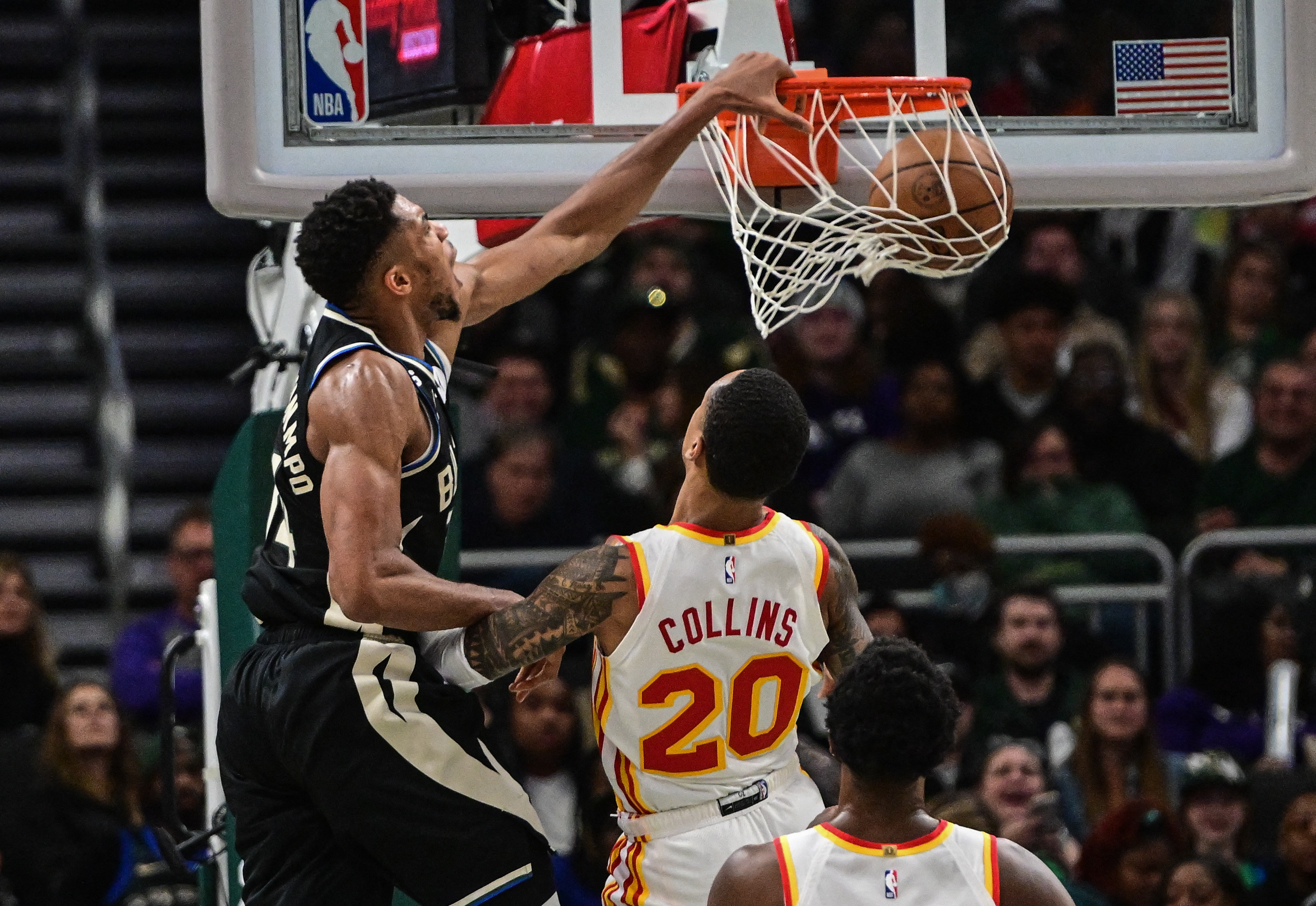Oct 29, 2022; Milwaukee, Wisconsin, USA; Milwaukee Bucks forward Giannis Antetokounmpo (34) dunks a basket against Atlanta Hawks forward John Collins (20) in the fourth quarter at Fiserv Forum. Mandatory Credit: Benny Sieu-USA TODAY Sports