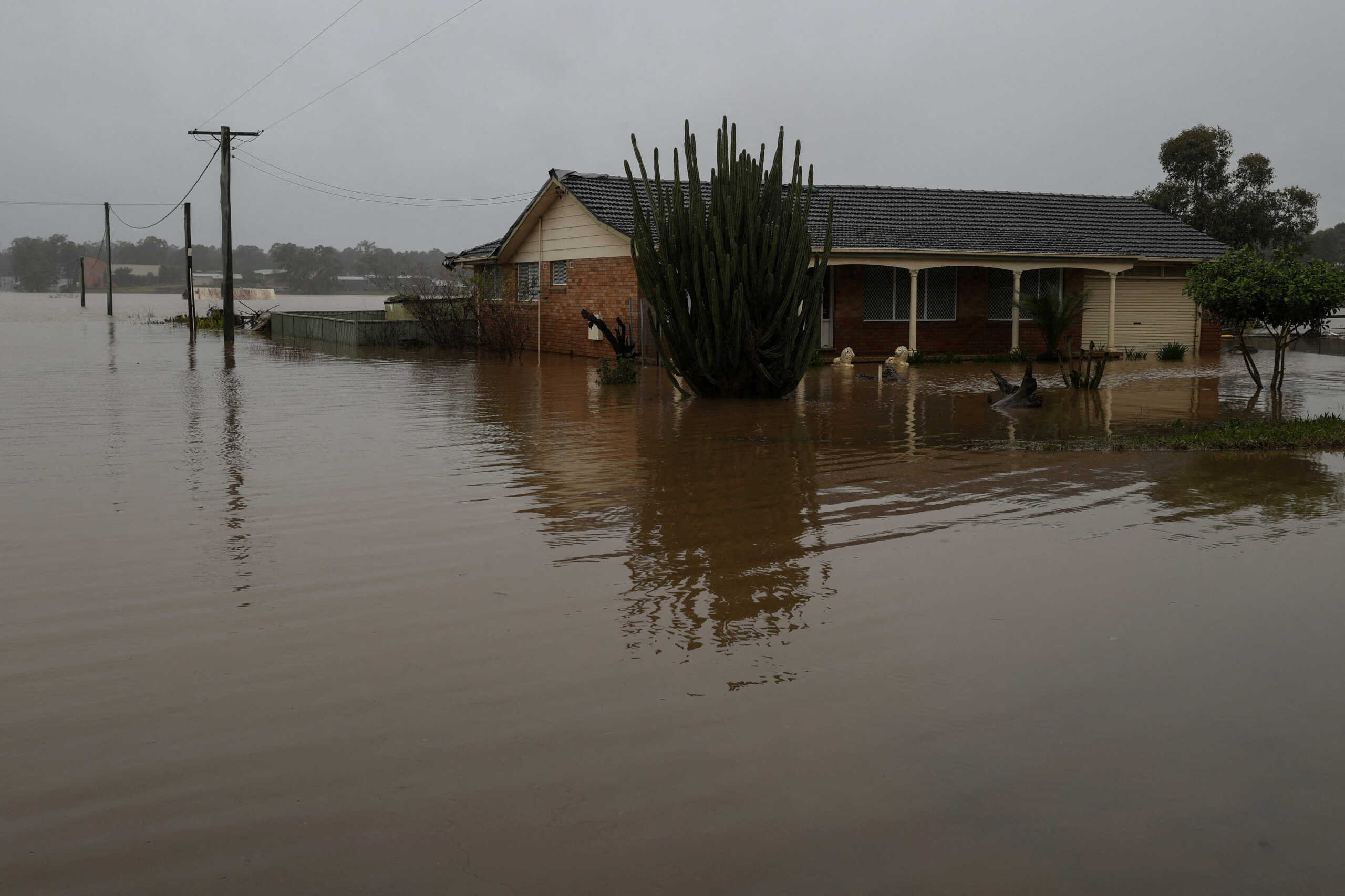 FILE PHOTO: A home is inundated by floodwaters, following heavy rains and severe flooding in the McGraths Hill suburb of Sydney, Australia, July 6, 2022. REUTERS