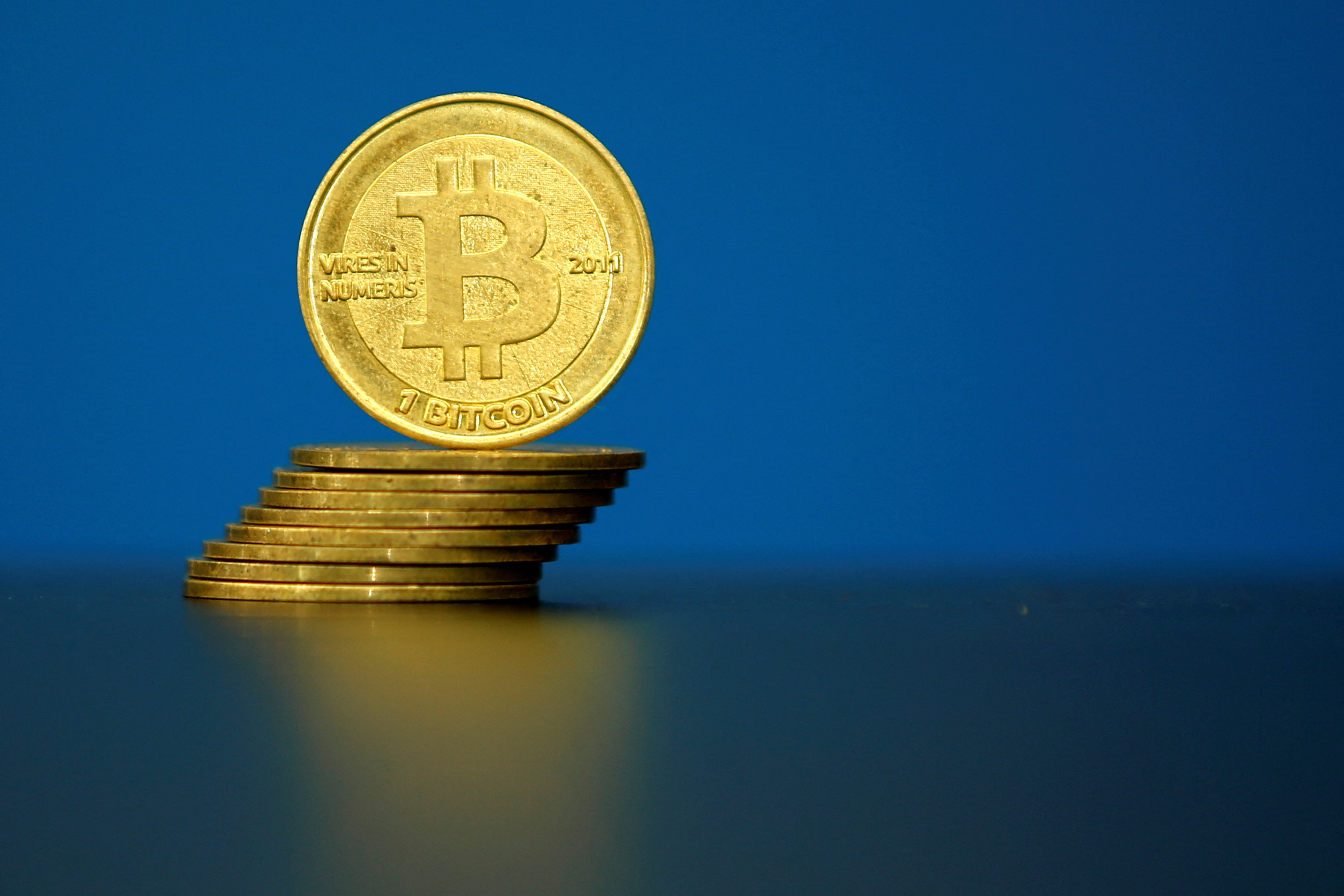 FILE PHOTO: Bitcoin (virtual currency) coins are seen in an illustration picture taken at La Maison du Bitcoin in Paris, France, May 27, 2015. REUTERS