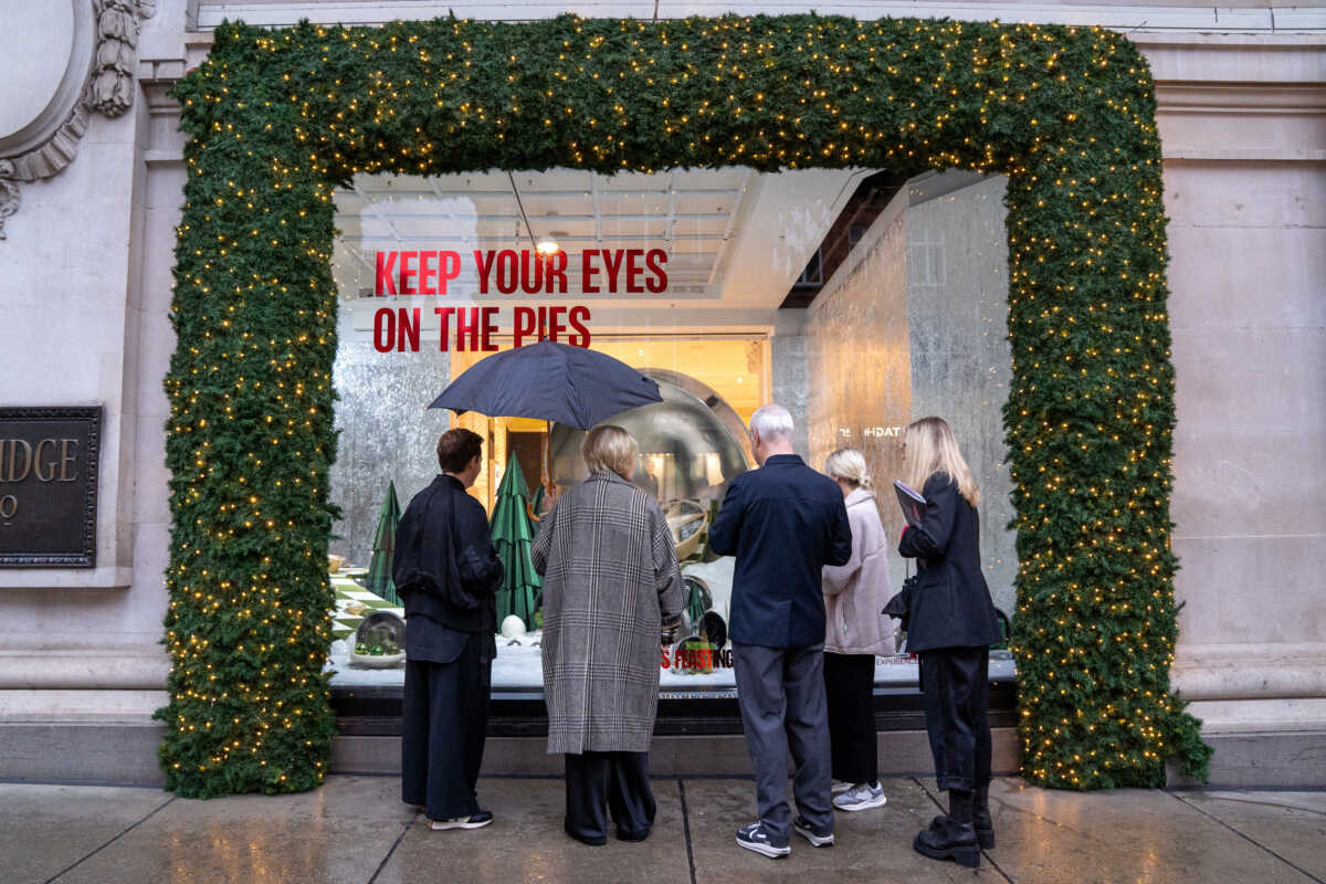 A performer dressed as Santa takes part in the unveiling of Selfridges department store's Christmas window display in London, Britain, October 27, 2022. REUTERS