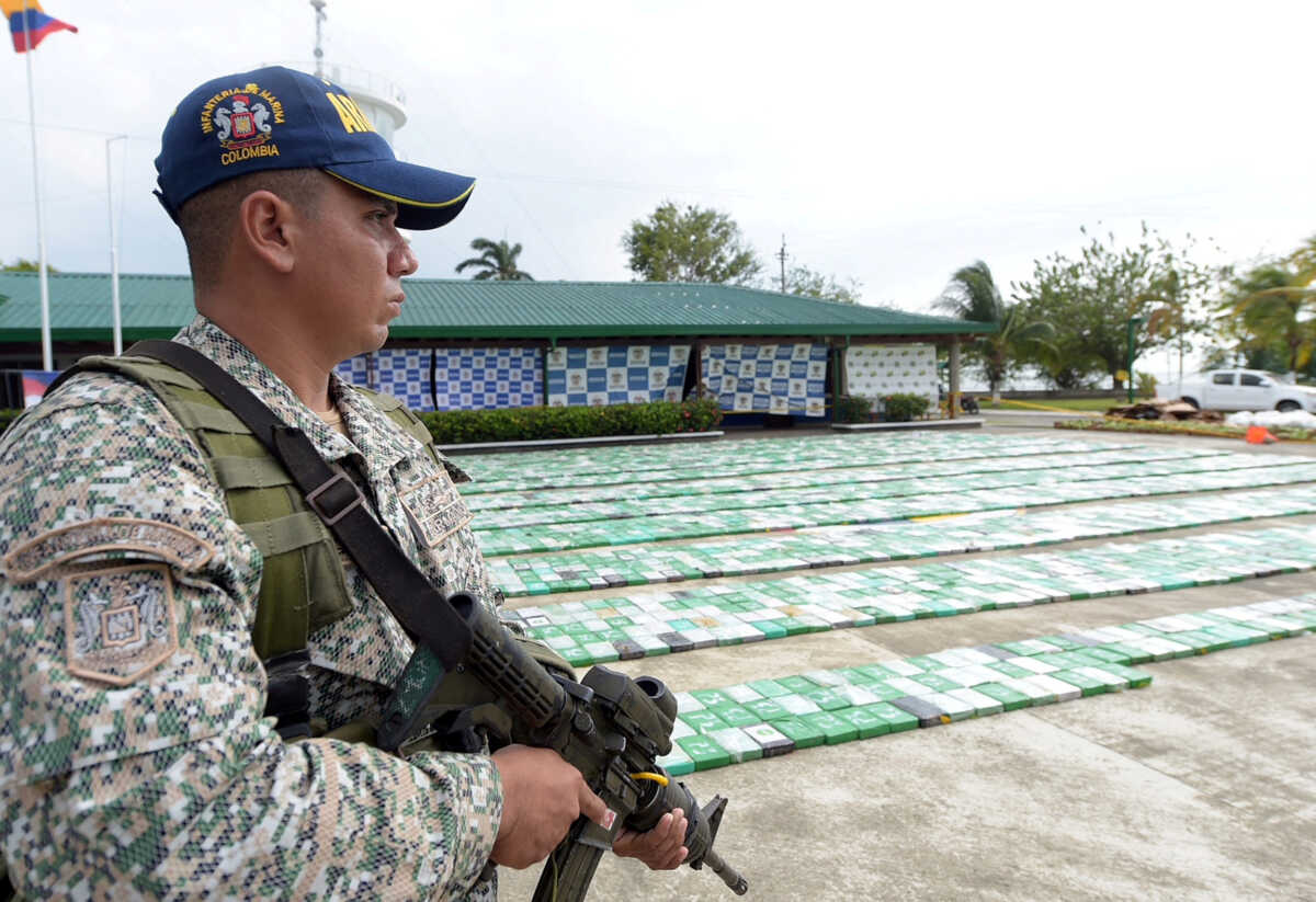 FILE PHOTO: A member of the Colombian navy stands guard along with 5.2 tons of cocaine that were seized in Turbo, Colombia March 6, 2018. Colombian Defense Ministry