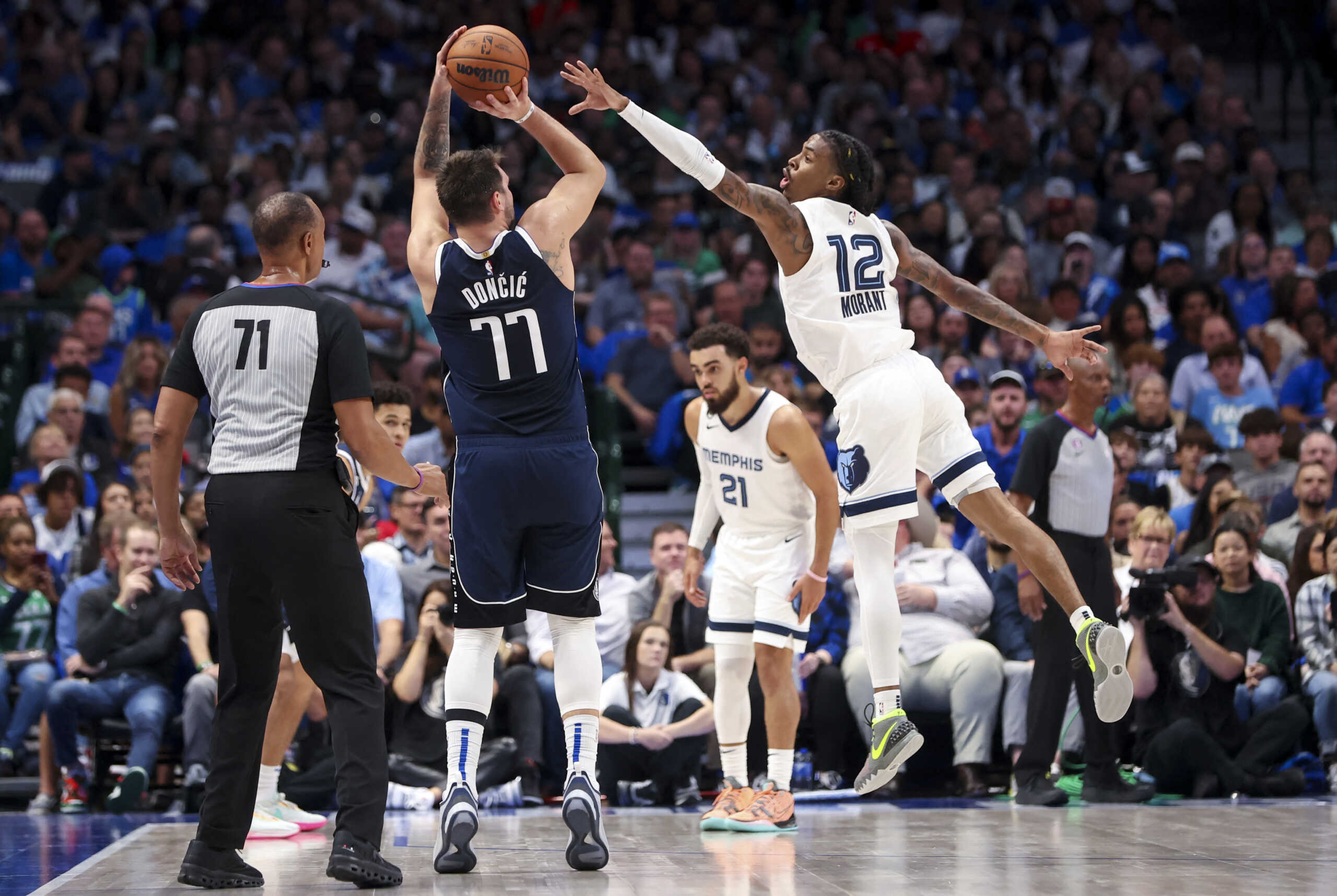 Oct 22, 2022; Dallas, Texas, USA; Dallas Mavericks guard Luka Doncic (77) shoots over Memphis Grizzlies guard Ja Morant (12) during the second half at American Airlines Center. Mandatory Credit: Kevin Jairaj-USA TODAY Sports