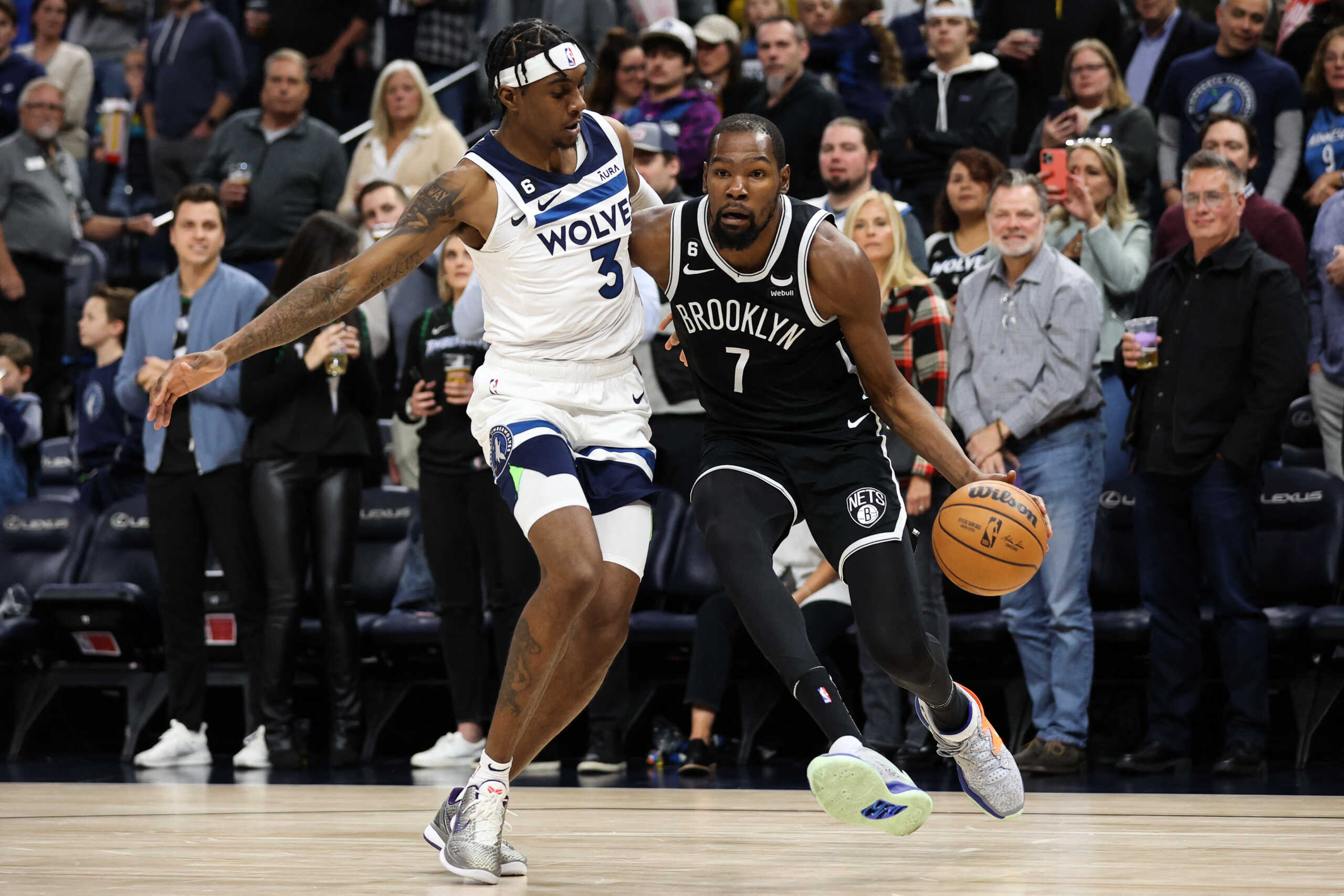 Oct 14, 2022; Minneapolis, Minnesota, USA; Brooklyn Nets forward Kevin Durant (7) drives towards the net while Minnesota Timberwolves forward Jaden McDaniels (3) defends during the first quarter at Target Center. Mandatory Credit: Matt Krohn-USA TODAY Sports