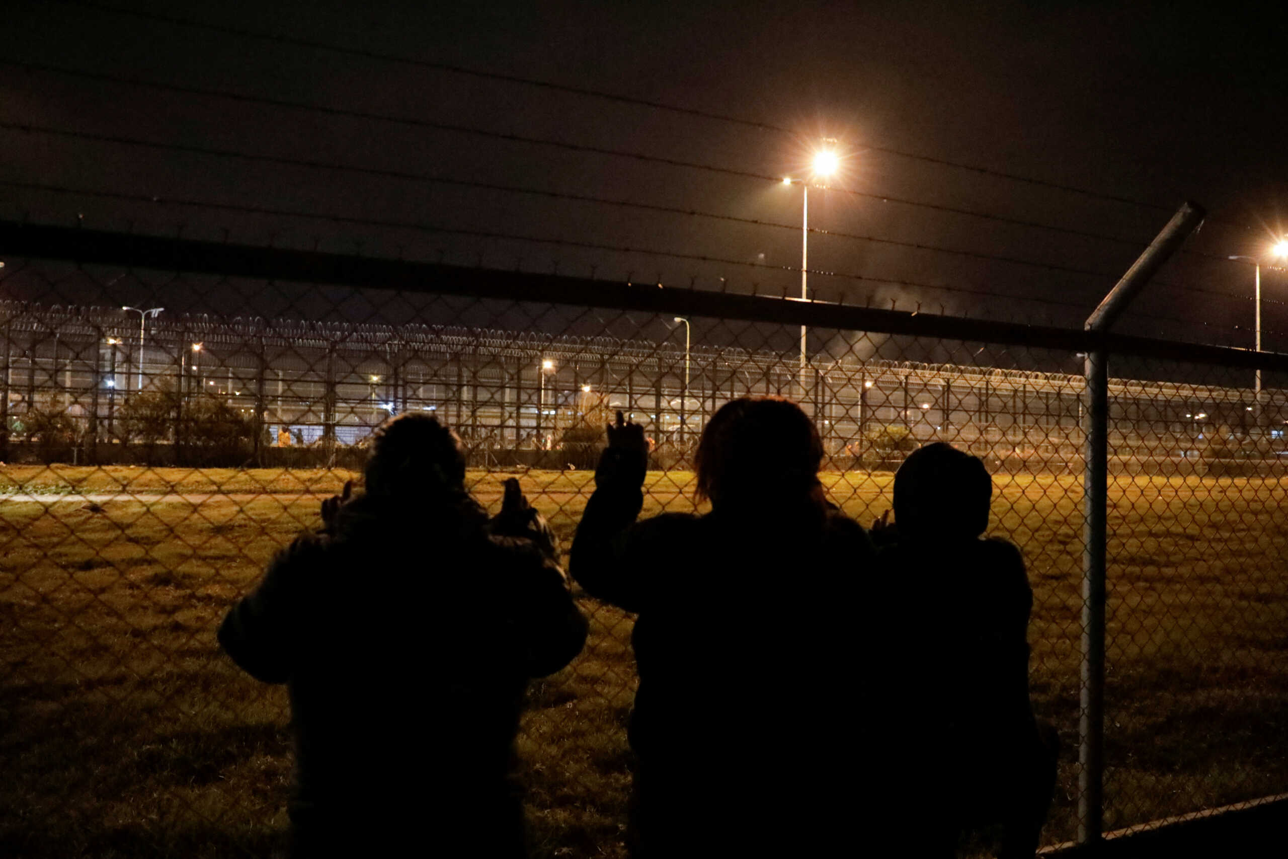 Family members of inmates look through the fence at the Cotopaxi No 1 penitentiary while waiting for news on their loved ones, in Latacunga, Ecuador October 3, 2022. REUTERS