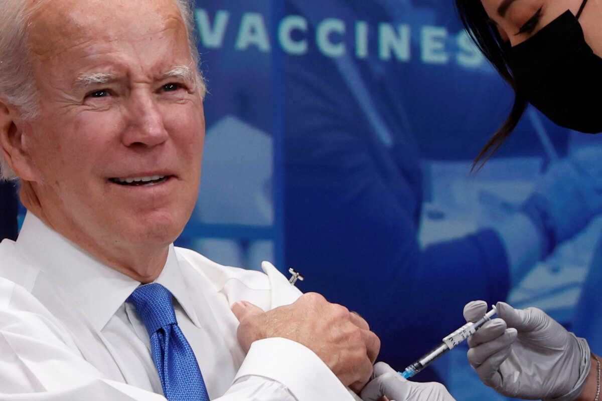 U.S. President Joe Biden receives an updated coronavirus disease (COVID-19) vaccine onstage in an auditorium on the White House campus in Washington, U.S. October 25, 2022. REUTERS