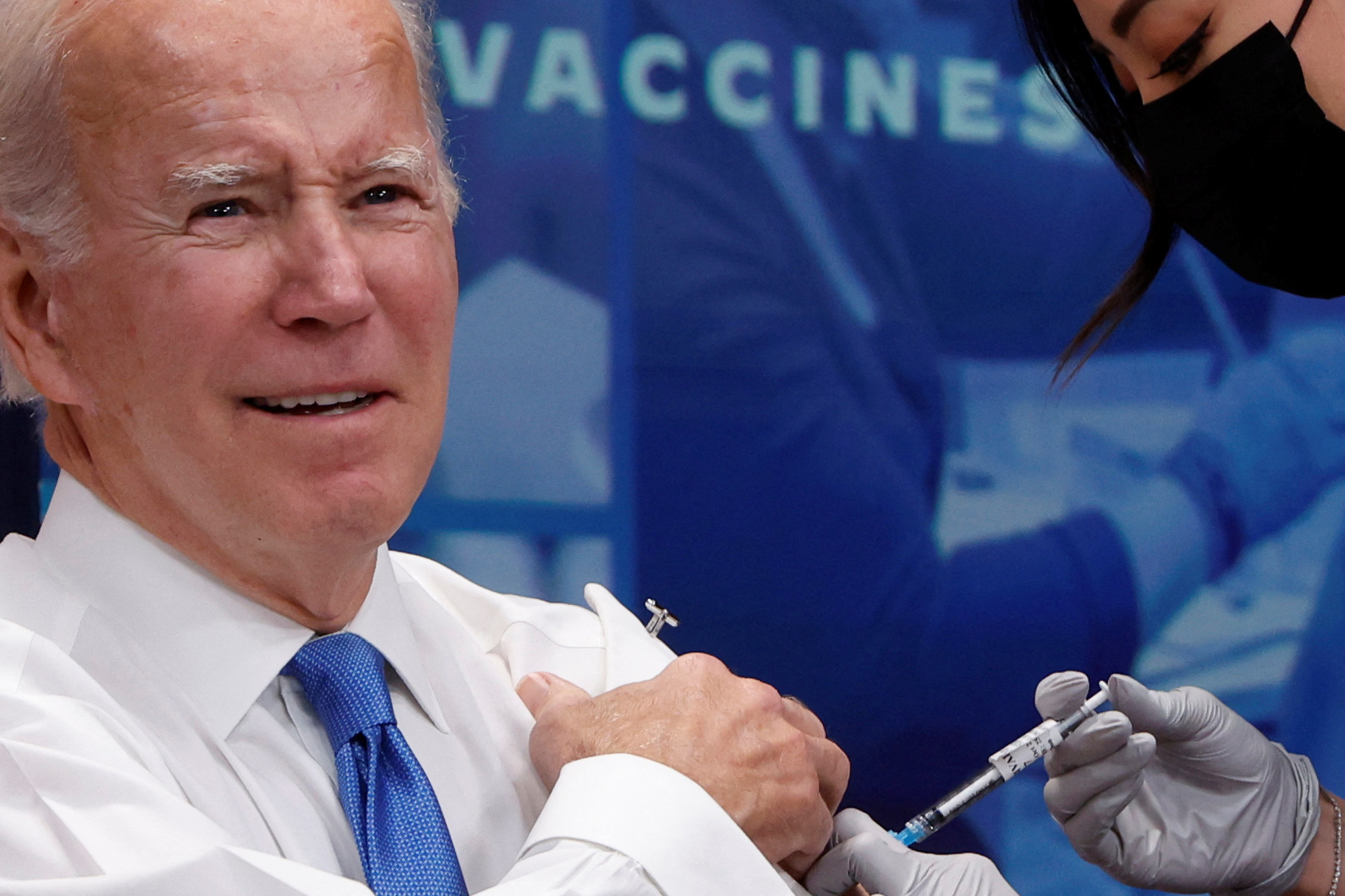 U.S. President Joe Biden receives an updated coronavirus disease (COVID-19) vaccine onstage in an auditorium on the White House campus in Washington, U.S. October 25, 2022. REUTERS