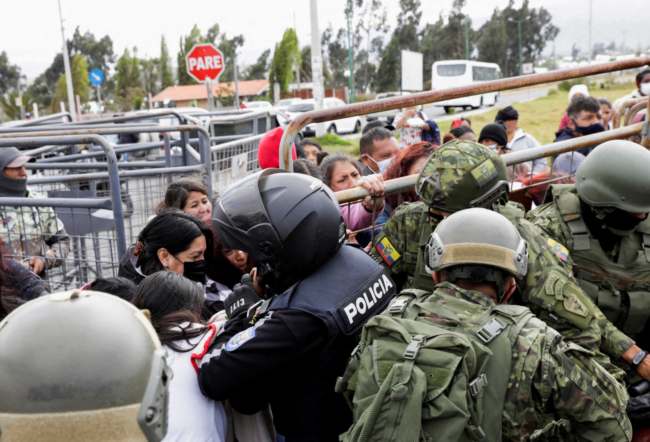 Relatives of inmates push fences while clashing with police as they try to find out if their loved ones were among the dead following a riot at the Cotopaxi No 1 penitentiary, in Latacunga, Ecuador October 4, 2022. REUTERS