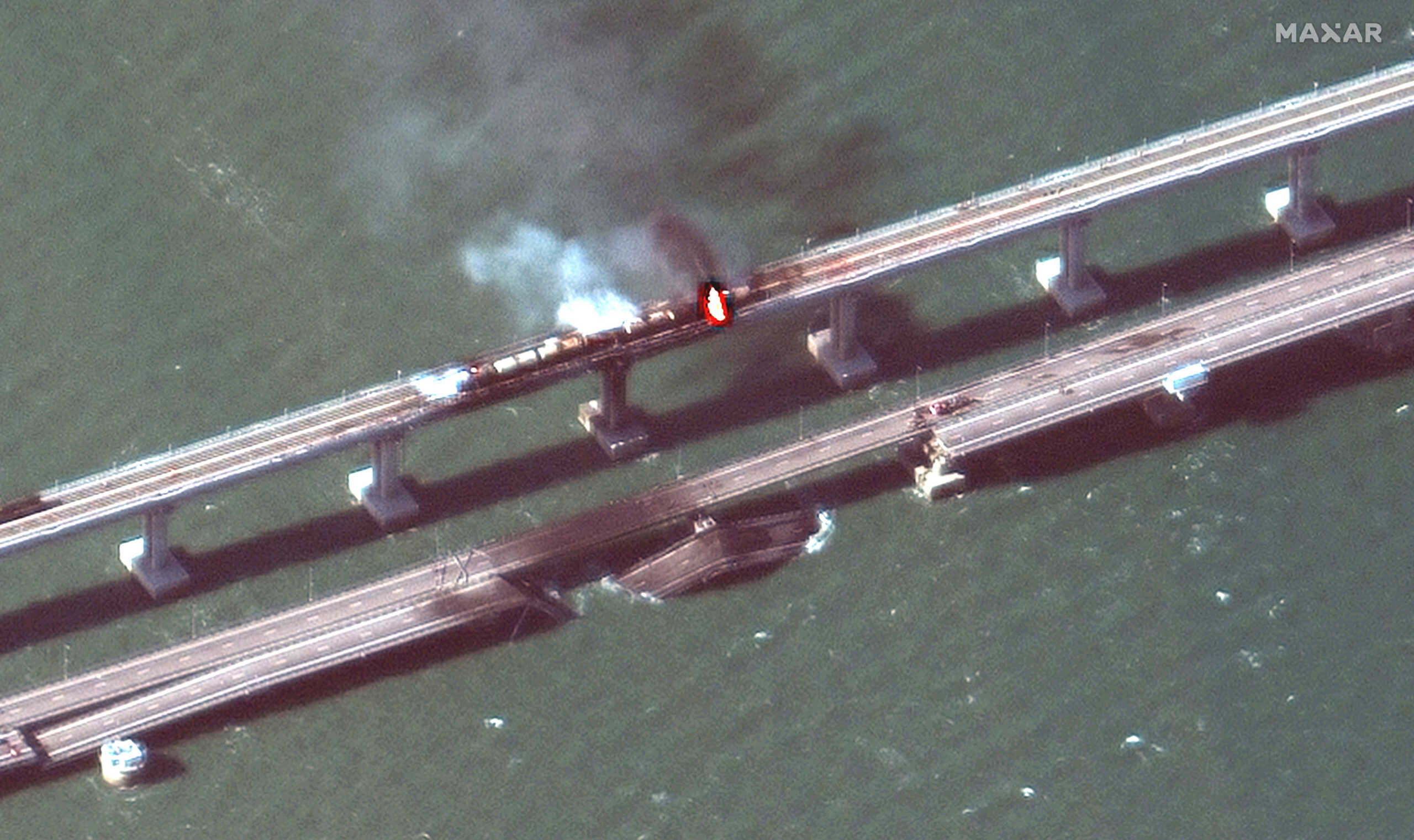 A satellite image shows a close up view of smoke rising from a fire on the Kerch bridge in the Kerch Strait, Crimea, October 8, 2022. Maxar Technologies