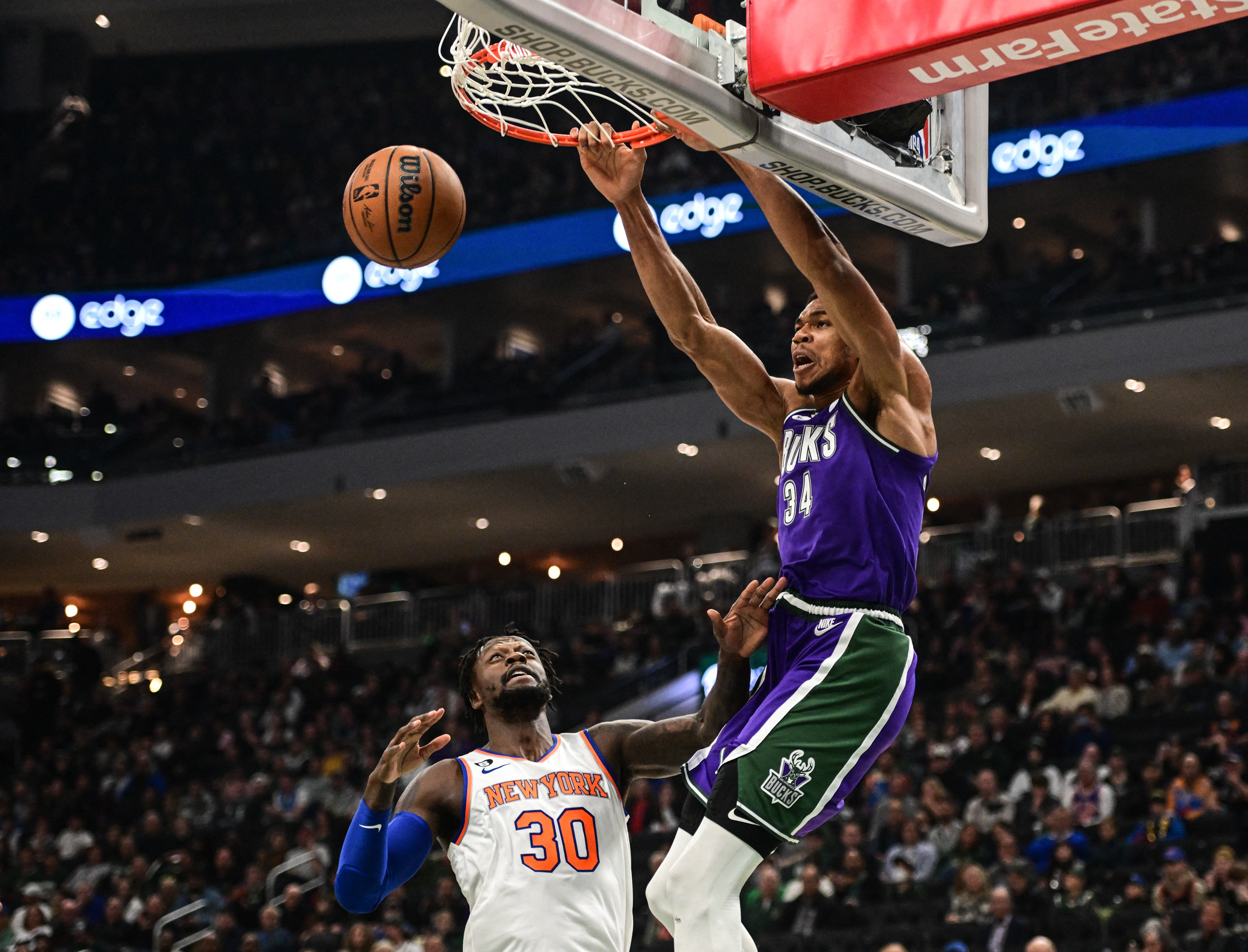 Oct 28, 2022; Milwaukee, Wisconsin, USA;  Milwaukee Bucks forward Giannis Antetokounmpo (34) dunks over New York Knicks forward Julius Randle (30) in the first quarter at Fiserv Forum. Mandatory Credit: Benny Sieu-USA TODAY Sports