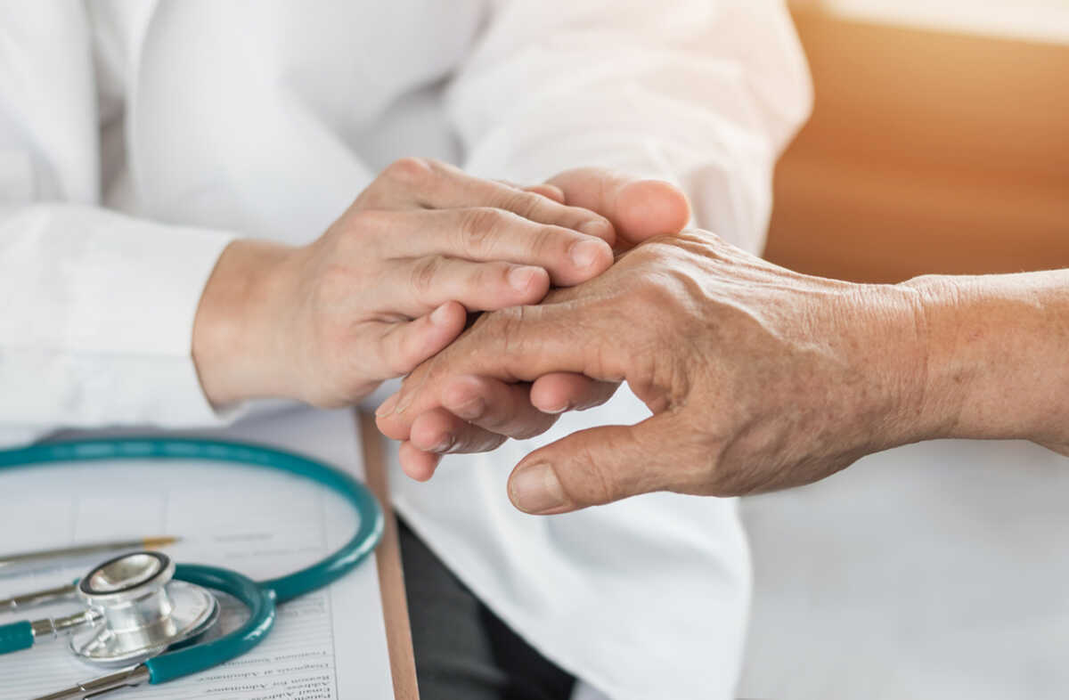 Elderly senior adult patient (older person) having geriatric doctor consulting and diagnostic examining on aging and mental health care in medical clinic office or hospital examination room