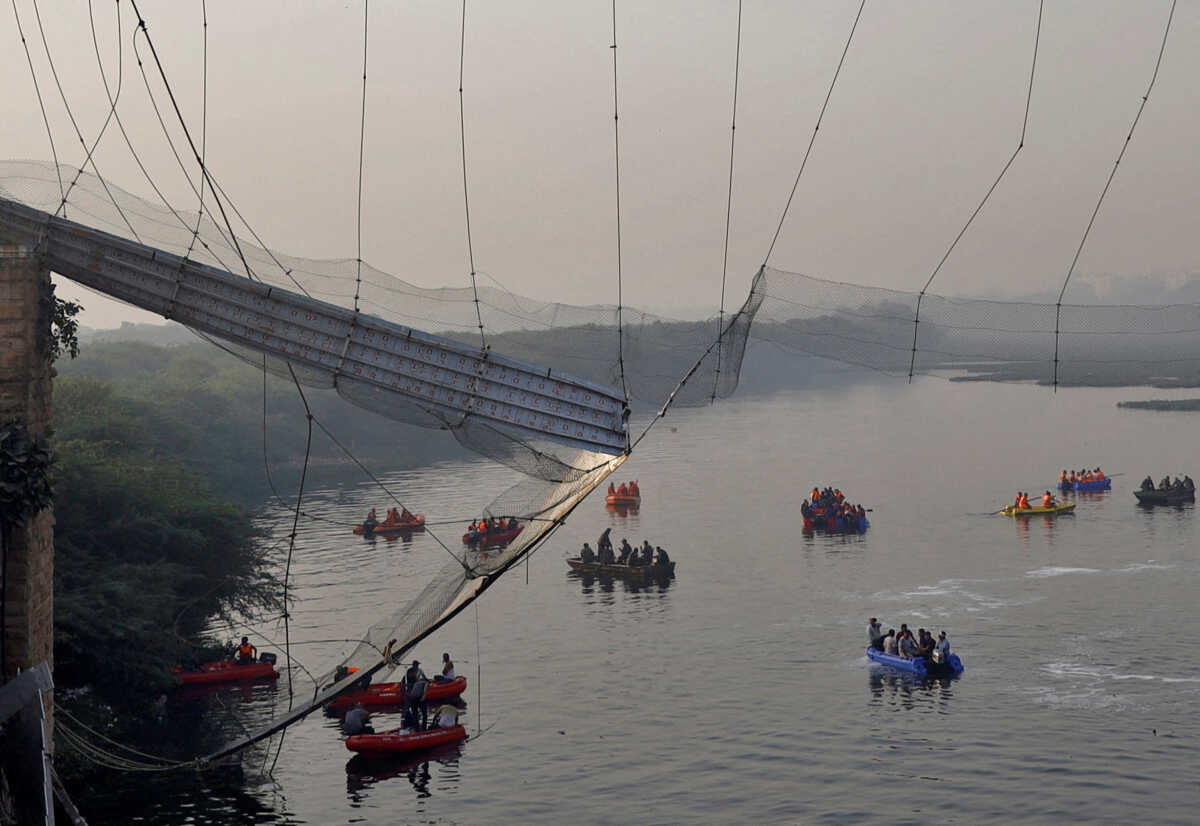 Rescuers search for survivors after a suspension bridge collapsed in Morbi town in the western state of Gujarat, India, October 31, 2022. REUTERS