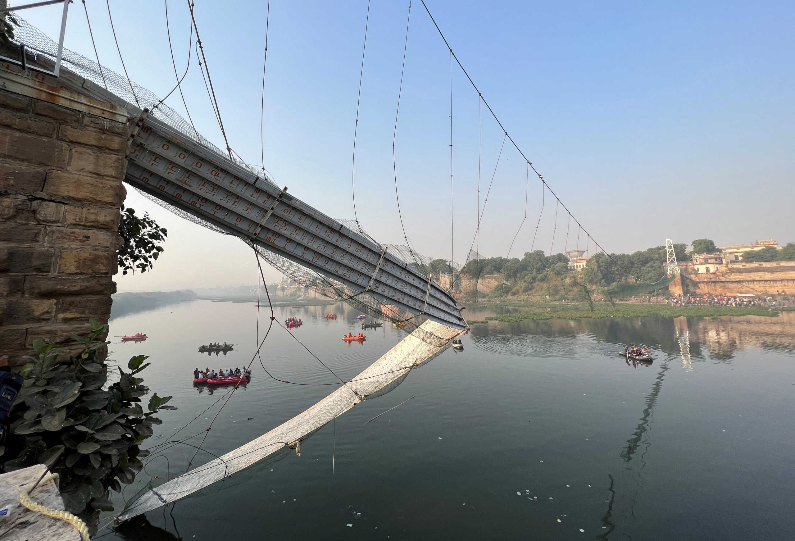 Rescuers search for survivors after a suspension bridge collapsed in Morbi town in the western state of Gujarat, India, October 31, 2022. REUTERS