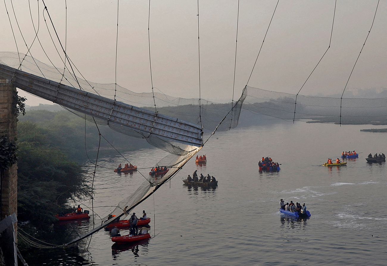 Rescuers search for survivors after a suspension bridge collapsed in Morbi town in the western state of Gujarat, India, October 31, 2022. REUTERS