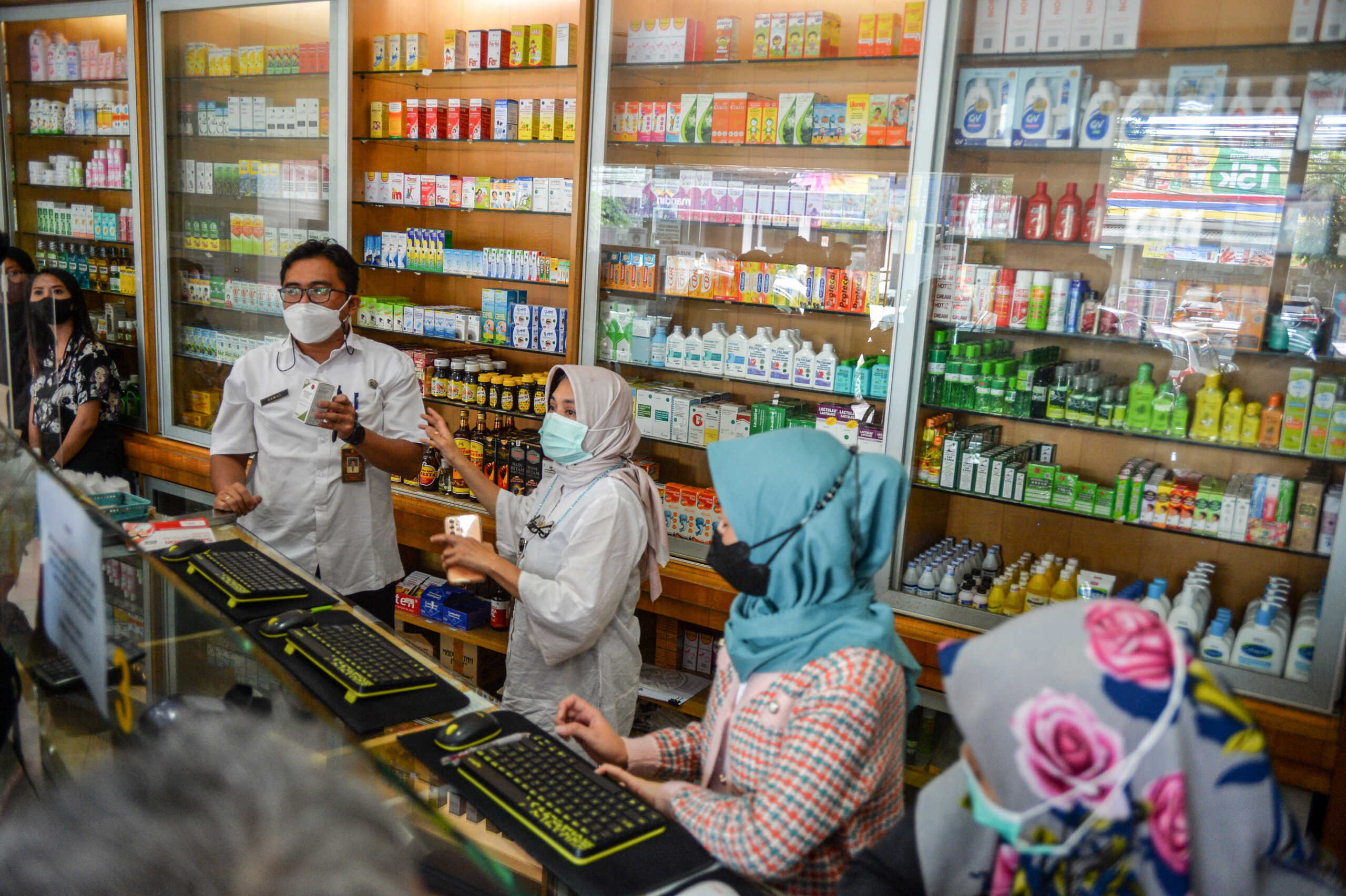 Health officers inspect medicinal syrups containing?ethylene glycol and diethylene glycol at a pharmacy in Bandung, West Java province, Indonesia, October 26, 2022, in this photo taken by Antara Foto. Antara Foto