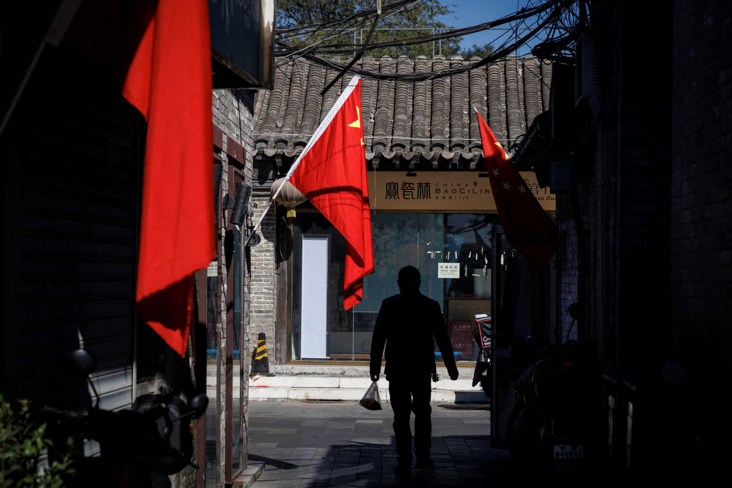 A view of Chinese national flags in an alley of an old neighbourhood as the city prepares for the 20th National Congress of the Communist Party of China, in Beijing, China October 11, 2022. REUTERS