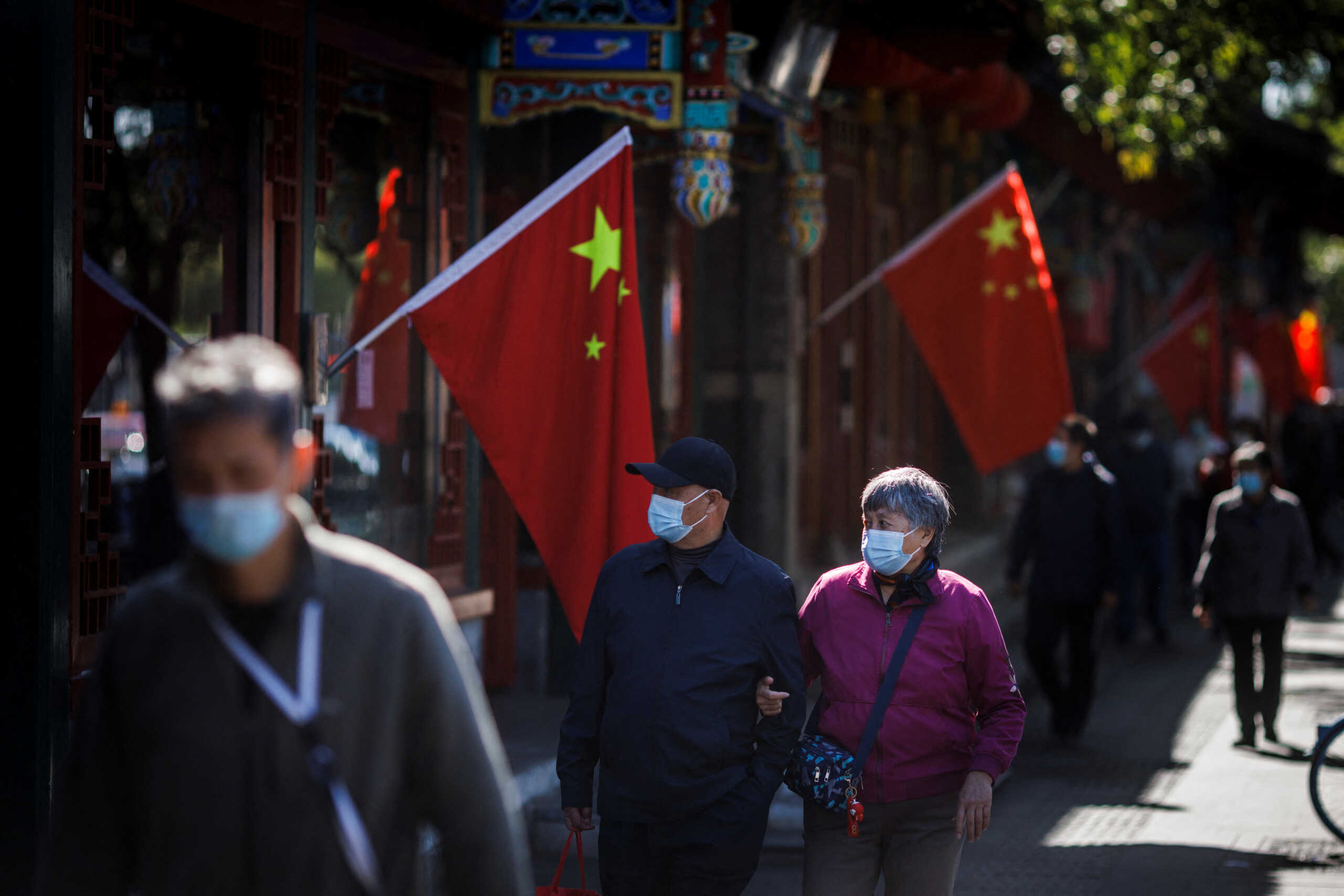 A view of Chinese national flags in a street of an old neighbourhood as the city prepares for the 20th National Congress of the Communist Party of China, in Beijing, China October 11, 2022. REUTERS