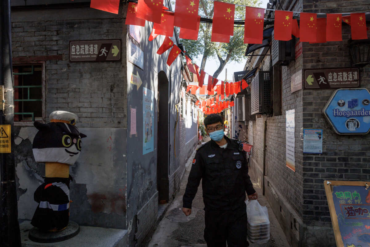 A view of Chinese national flags in an alley of an old neighbourhood as the city prepares for the 20th National Congress of the Communist Party of China, in Beijing, China October 11, 2022. REUTERS