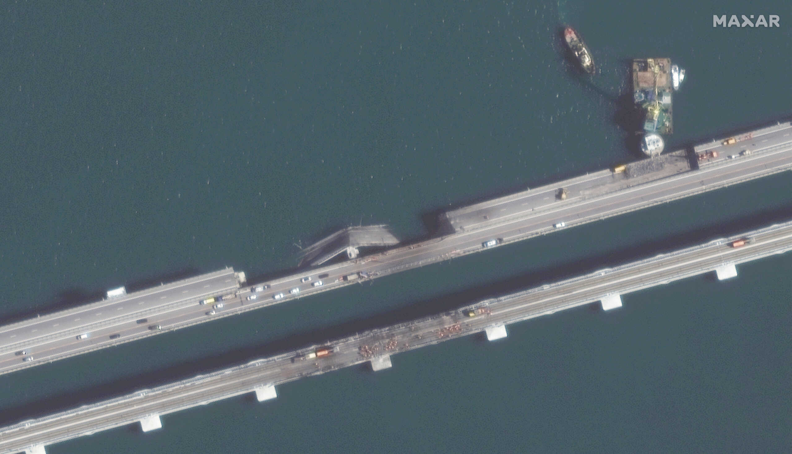 Close view of the traffic and the repair work on the Crimea Bridge over the Kerch Strait, in Kerch, Crimea October 12, 2022. Satellite image courtesy of 2022 Maxar Technologies