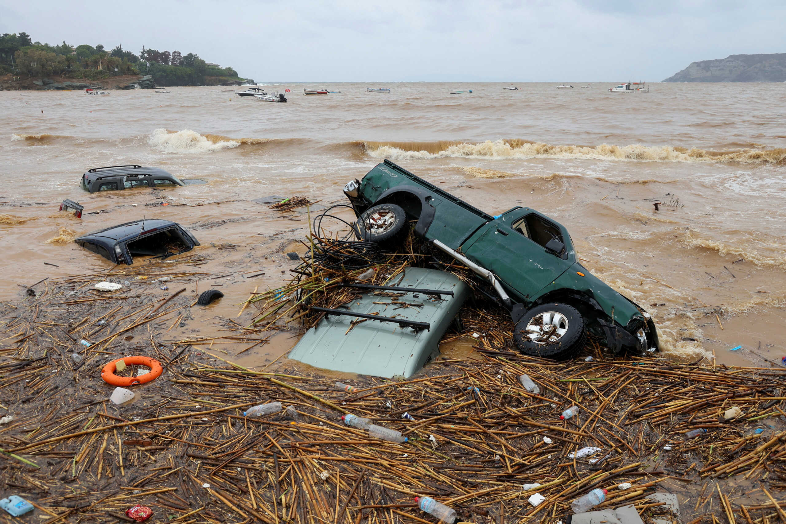 Damaged submerged cars are seen on the beach, following flash floods on the village of Agia Pelagia, on the island of Crete, Greece, October 15, 2022. REUTERS