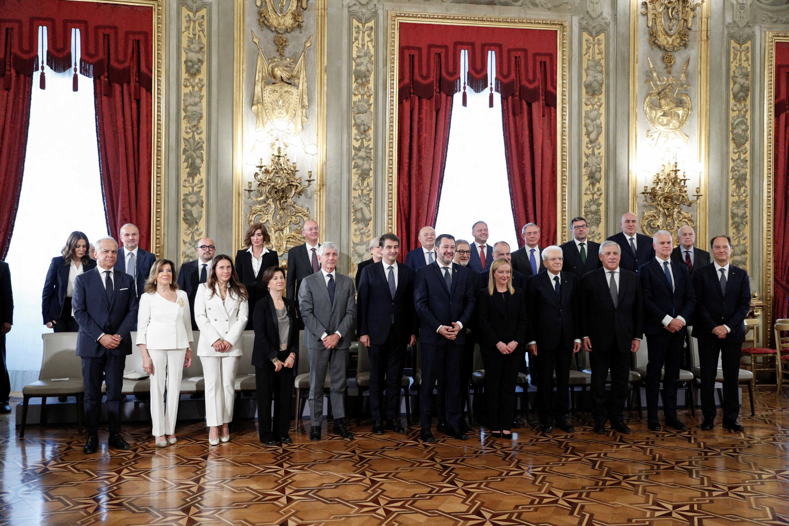 Italian President Sergio Mattarella and Prime Minister Giorgia Meloni stand with the government's new cabinet ministers on the day of the swearing-in ceremony, at the Quirinale Presidential Palace in Rome, Italy October 22, 2022. REUTERS