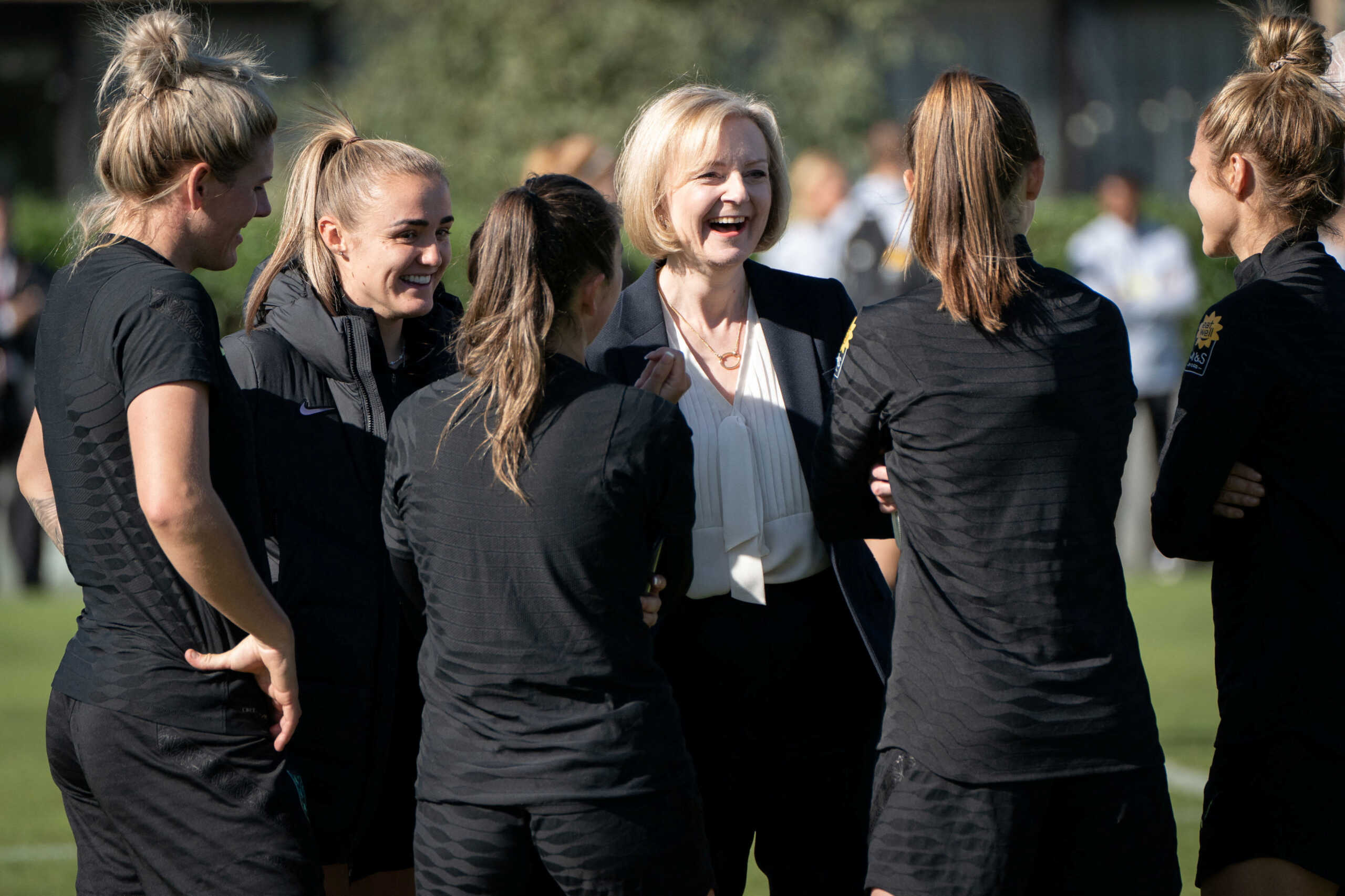 British Prime Minister Liz Truss chats with members of the England women's football team at the Lensbury Resort, in Teddington, south west London, Britain, October 10, 2022. Stefan Rousseau
