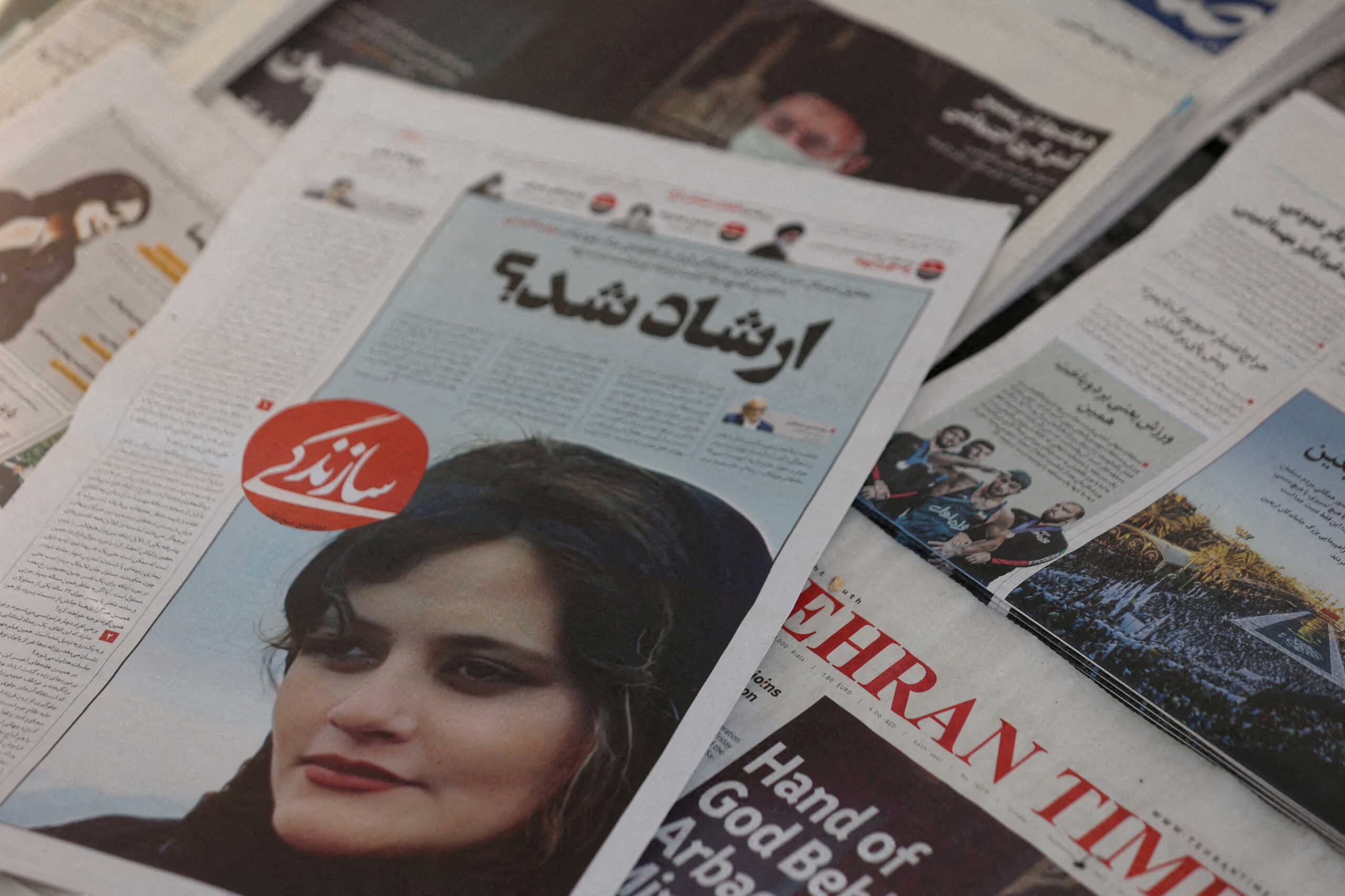FILE PHOTO: A newspaper with a cover picture of Mahsa Amini, a woman who died after being arrested by Iranian morality police is seen in Tehran, Iran, September 18, 2022. Majid Asgaripour