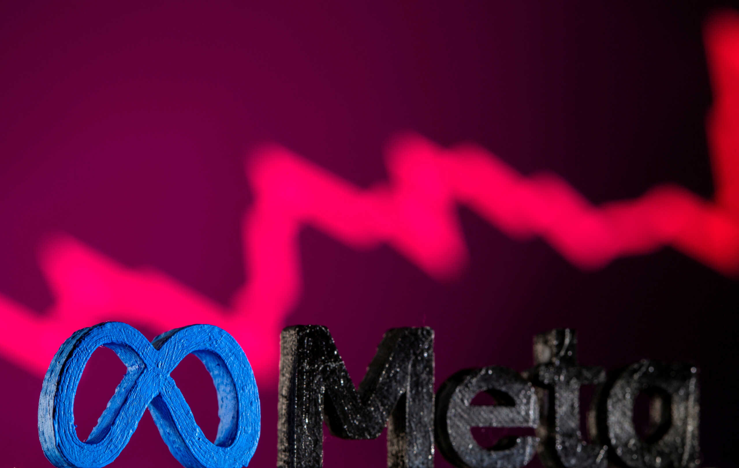 FILE PHOTO: A 3D printed Facebook's new rebrand logo Meta is seen in front of displayed stock graph in this illustration taken on November 2, 2021. REUTERS