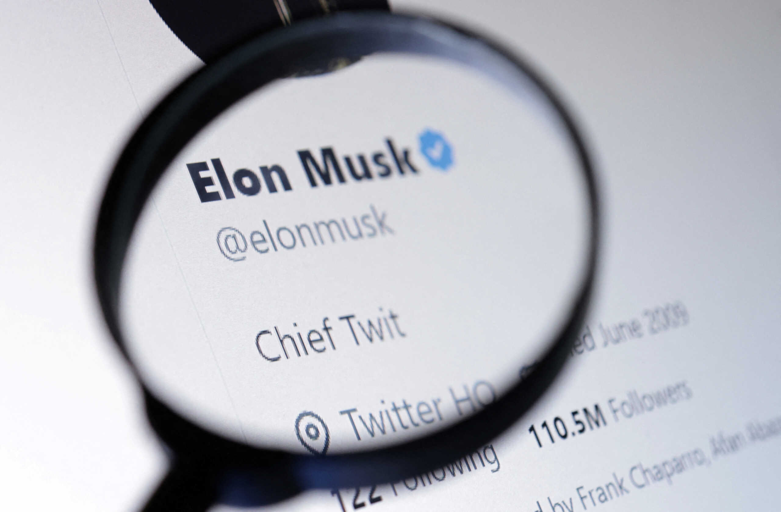 Elon Musk's Twitter account is seen through a magnifier in this illustration taken October 28, 2022. REUTERS