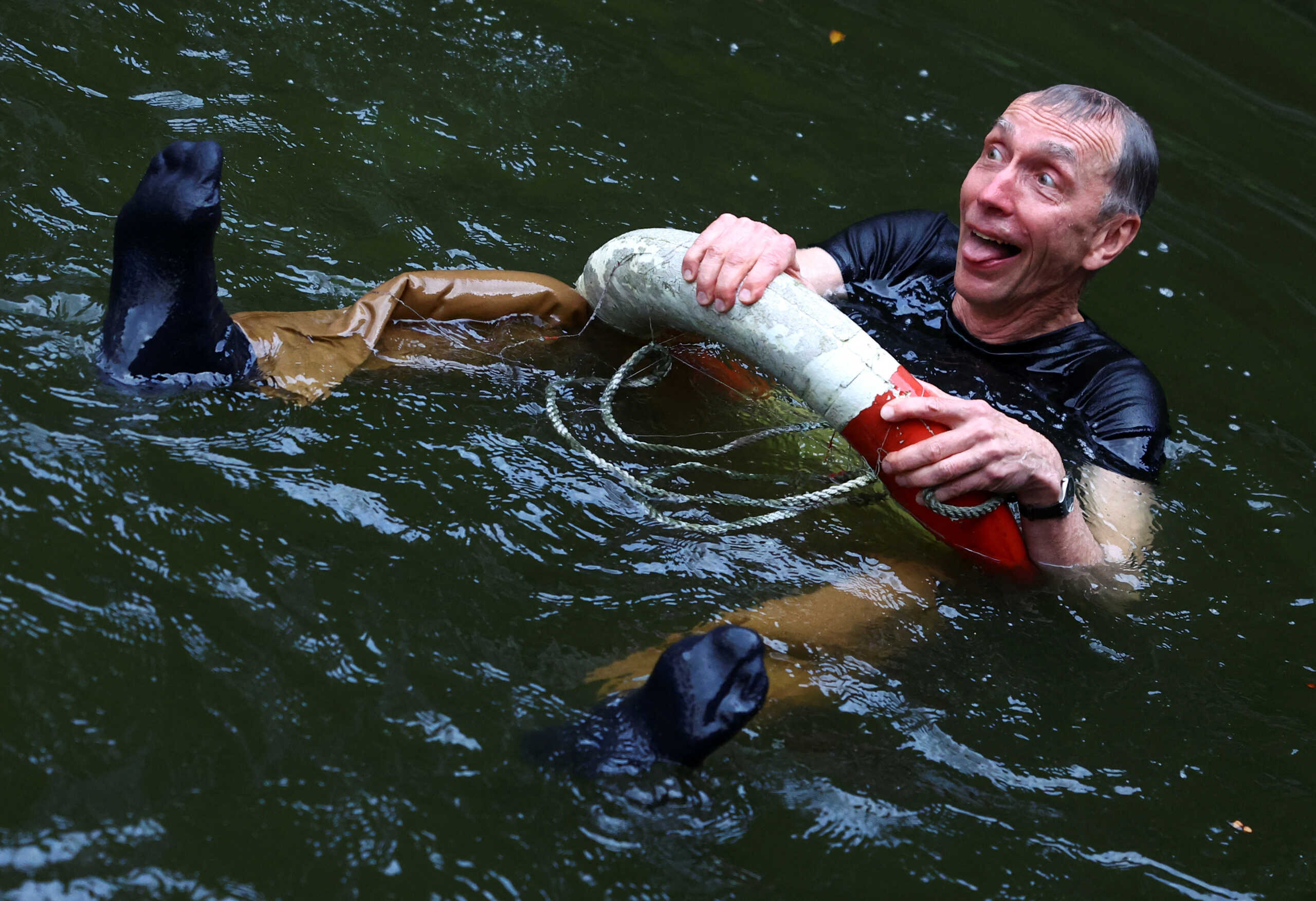 Swedish geneticist Svante Paabo, who won the 2022 Nobel Prize in Physiology or Medicine for discoveries that underpin our understanding of how modern day humans evolved from extinct ancestors, reacts after being thrown into the water by co-workers, at the Max-Planck Institute for evolutionary anthropology in Leipzig, Germany, October 3, 2022. REUTERS