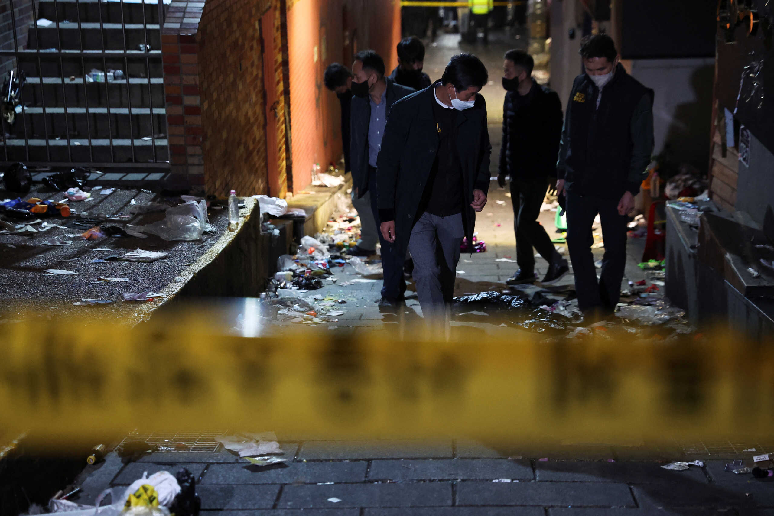 Investigators inspect the scene where many people died and were injured in a stampede during a Halloween festival in Seoul, South Korea, October 30, 2022. REUTERS