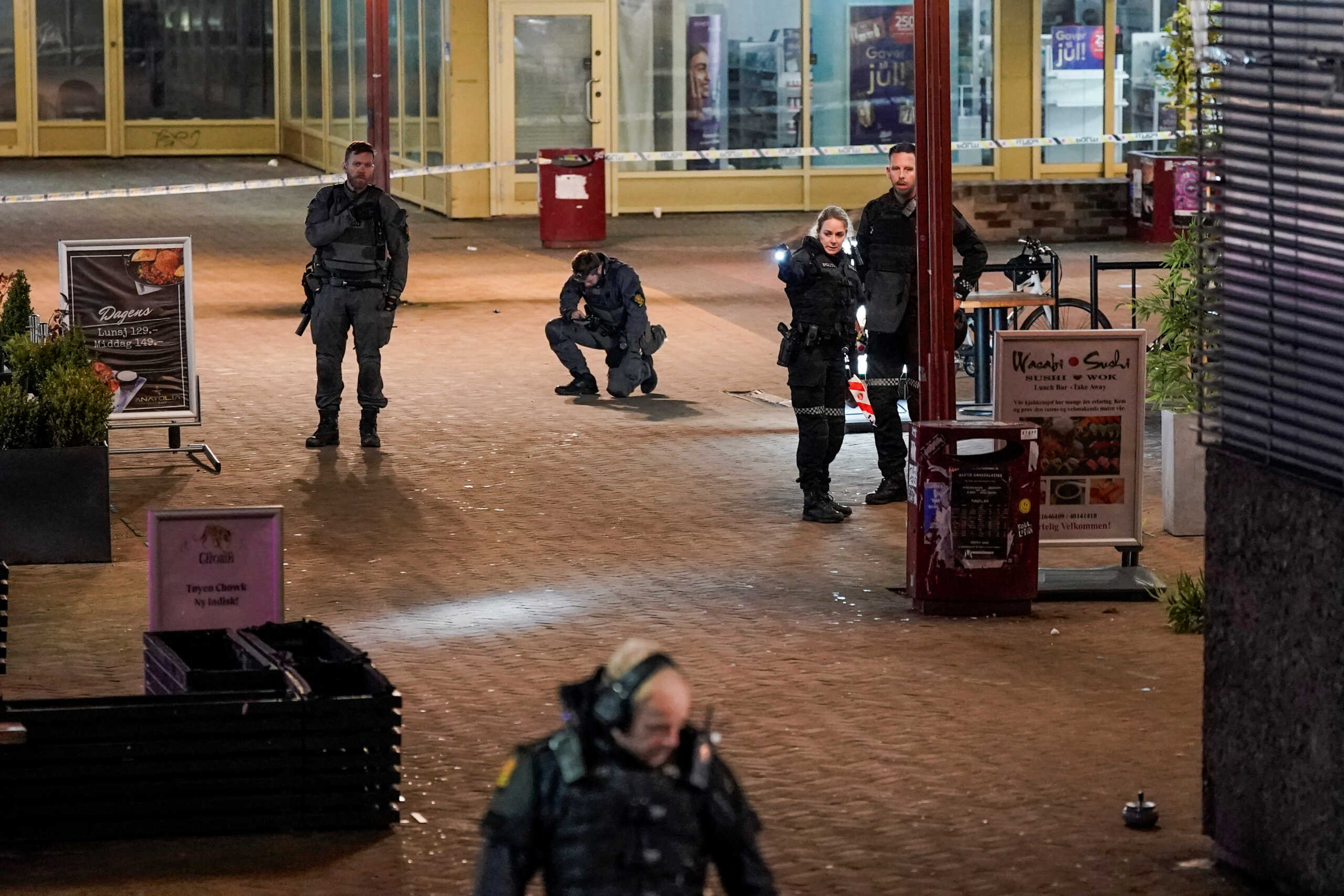 Police officers work in Toyen center after a shooting incident, in Oslo, Norway, October 22, 2022. NTB